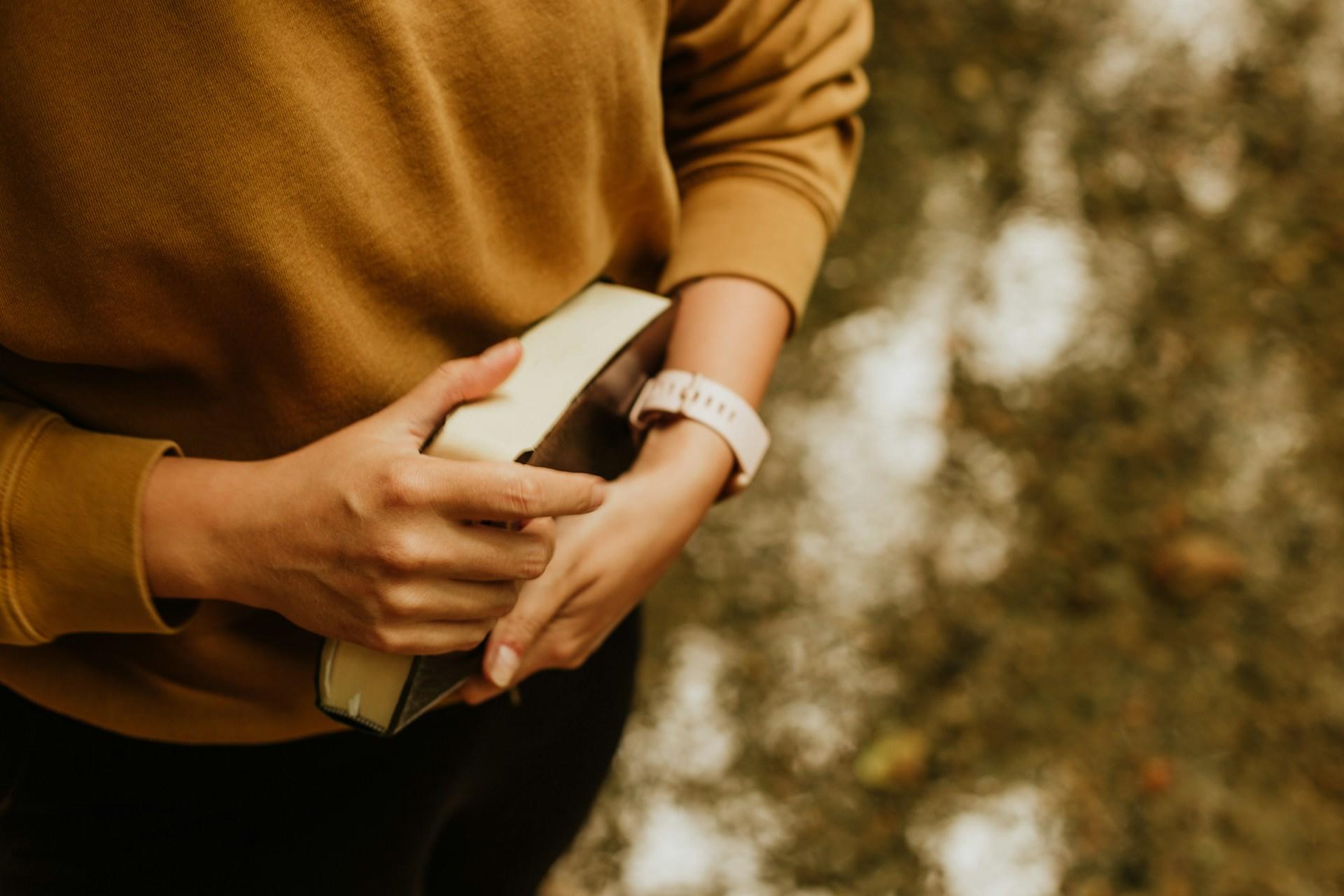 A student holding a book.