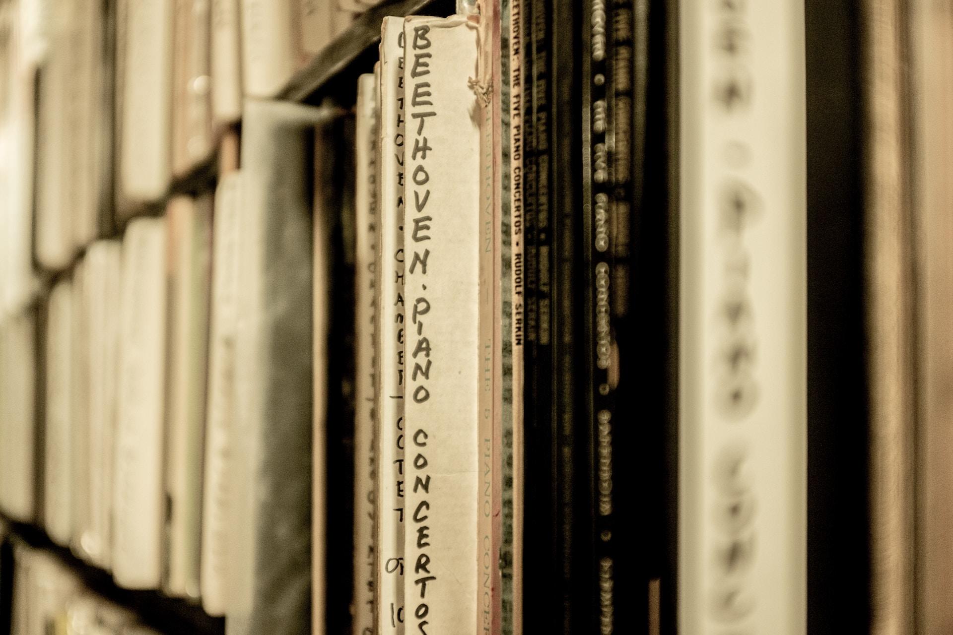 A rack full of sheet music with a selection of Beethoven's piano concertos pulled forward. 