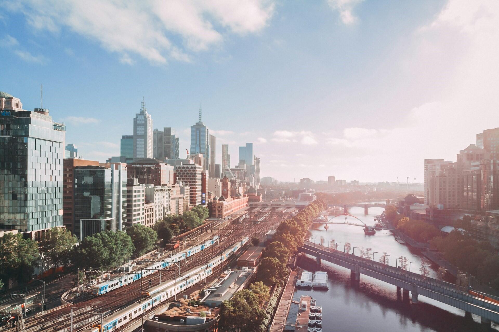 An aerial view of Melbourne, the river, and skyscrapers.