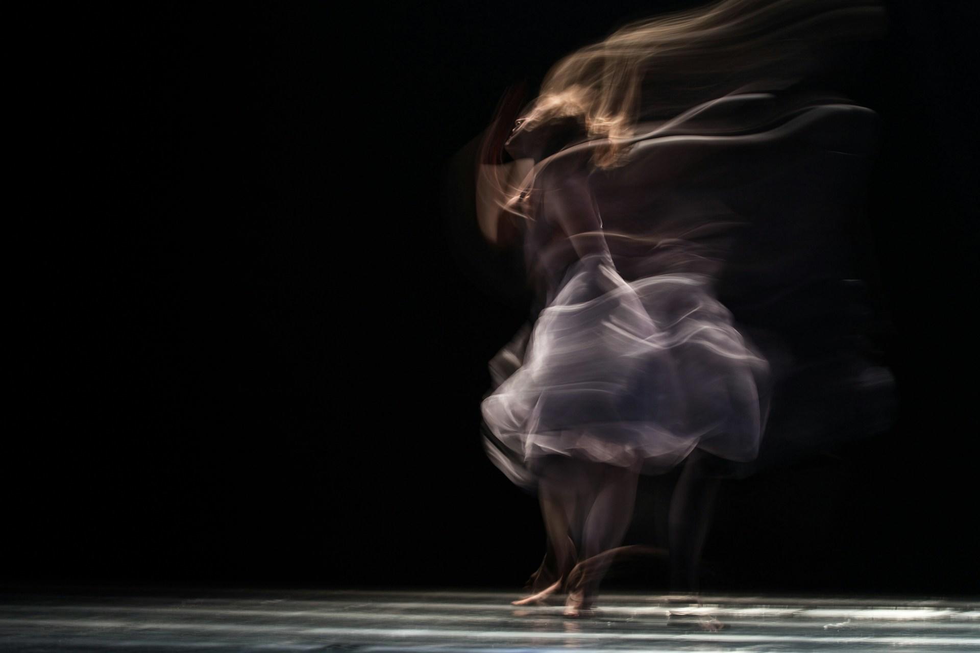 A blurry photo of a ballerina moving.