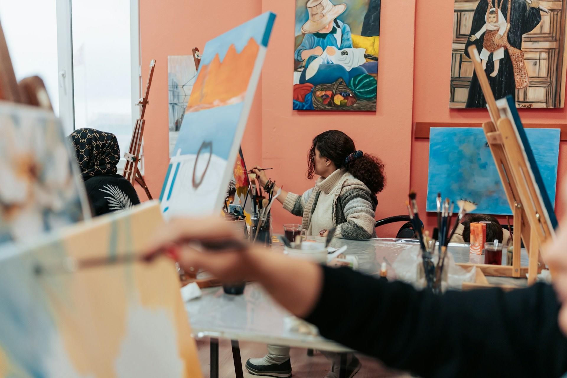 a group of people painting in a room