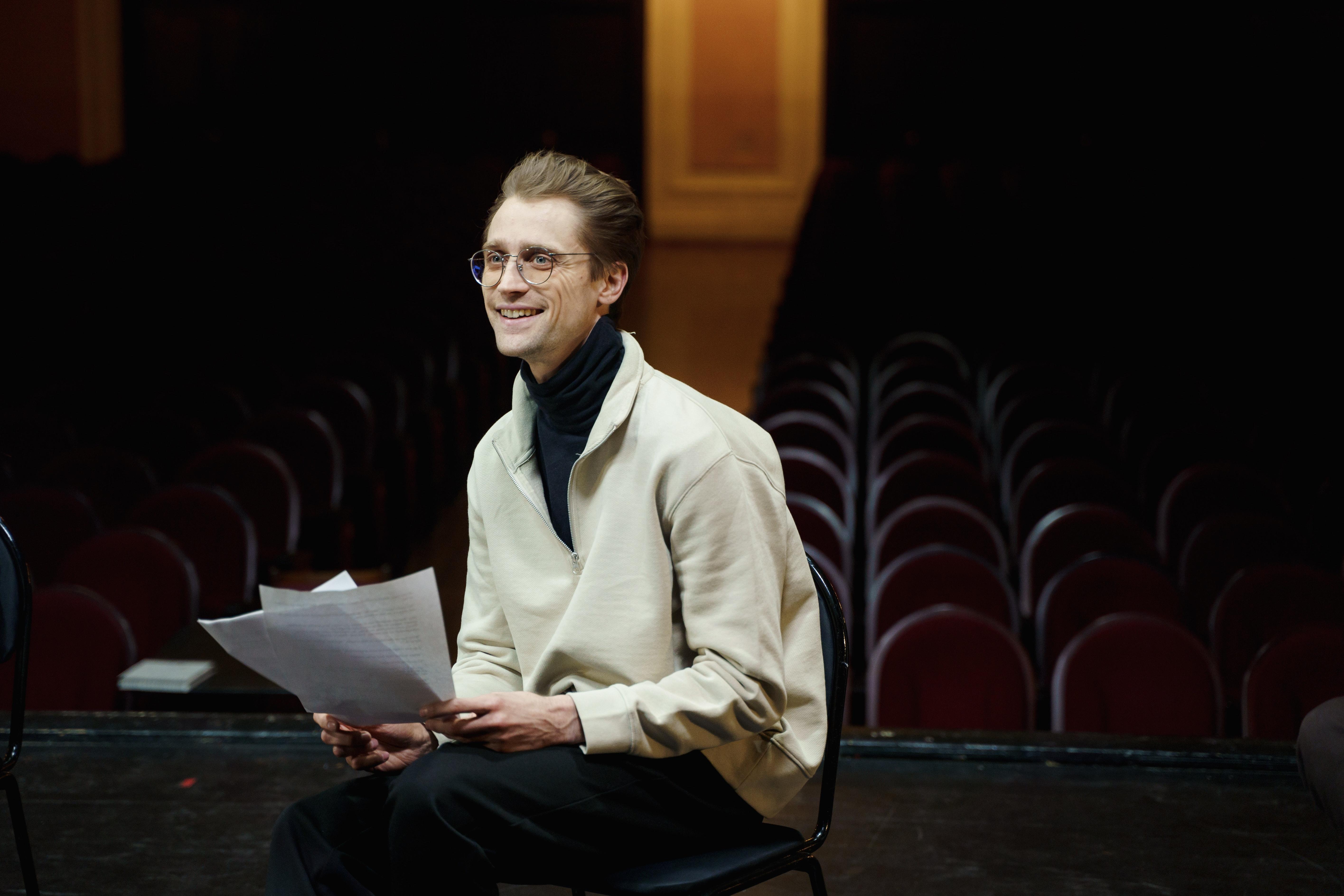 actor reading script onstage
