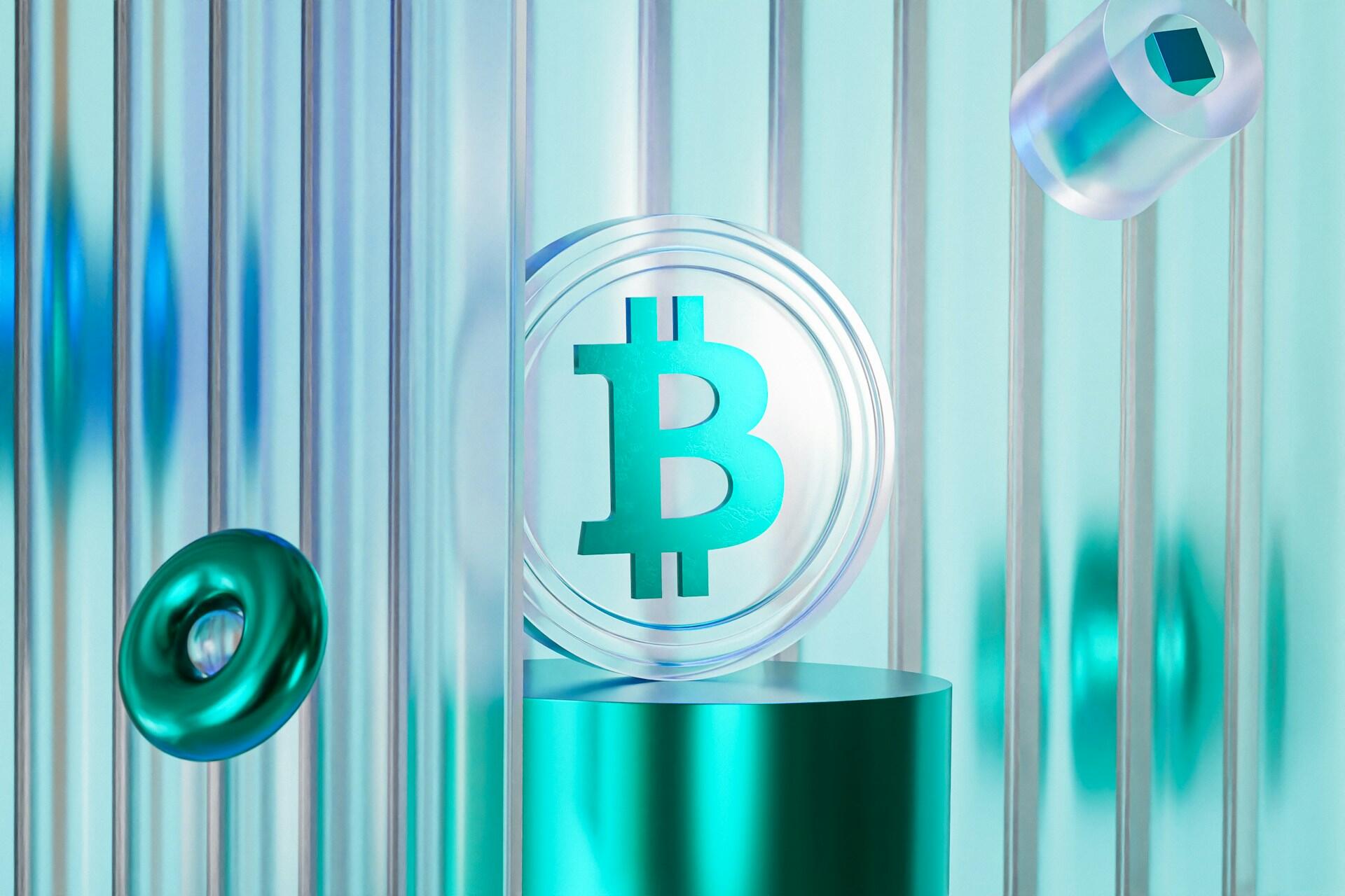 A translucent Bitcoin coin is displayed on a turquoise podium, surrounded by abstract geometric shapes and vertical lines.