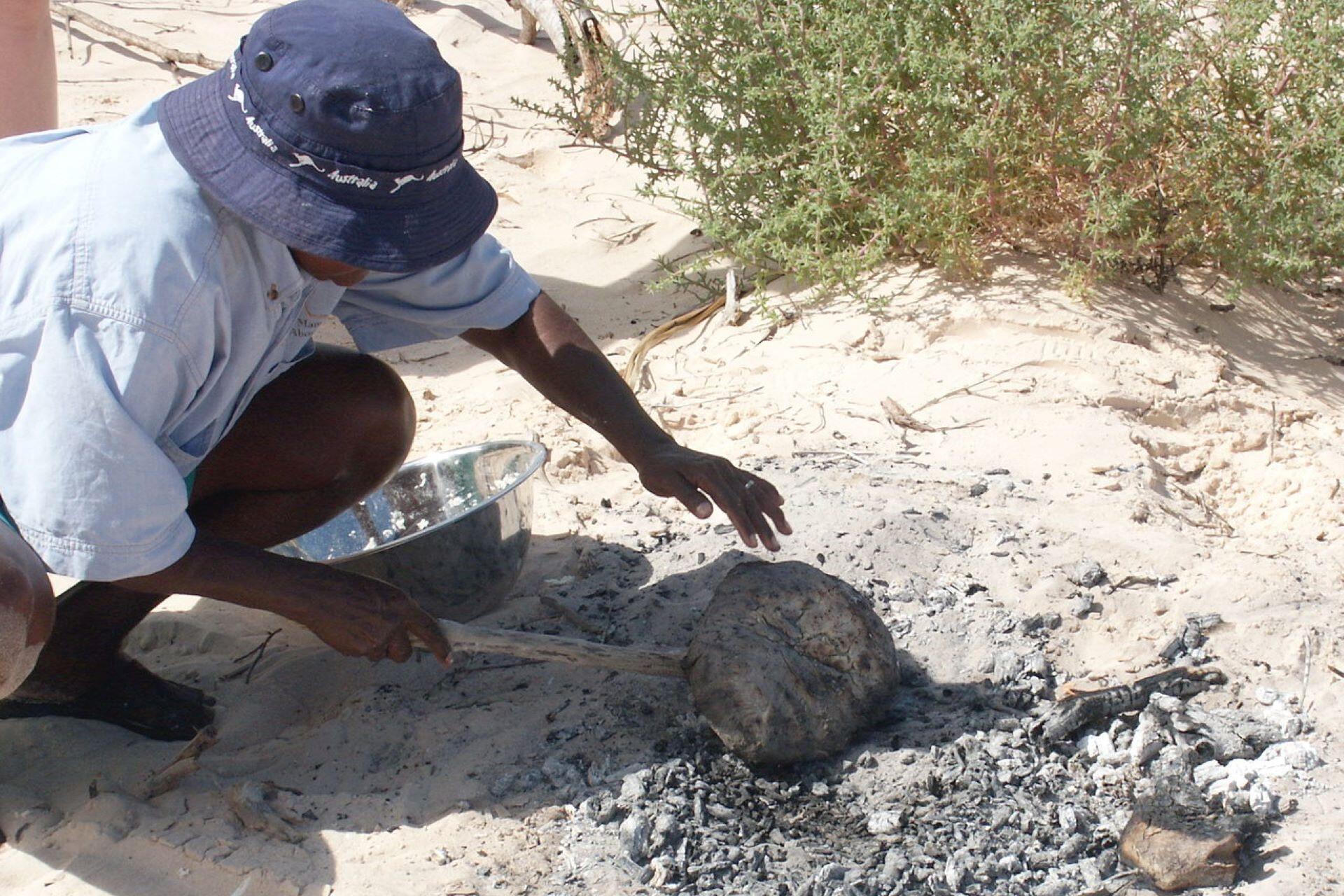 A man making damper bread.