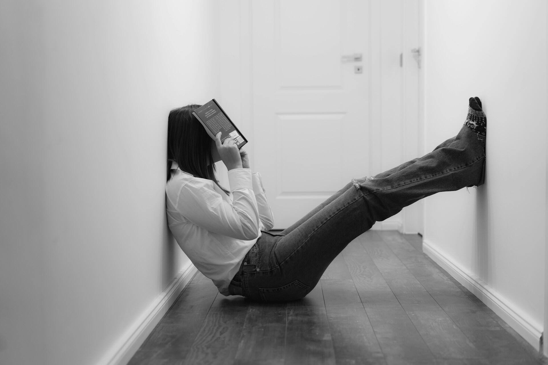 A stressed woman sitting on the floor.