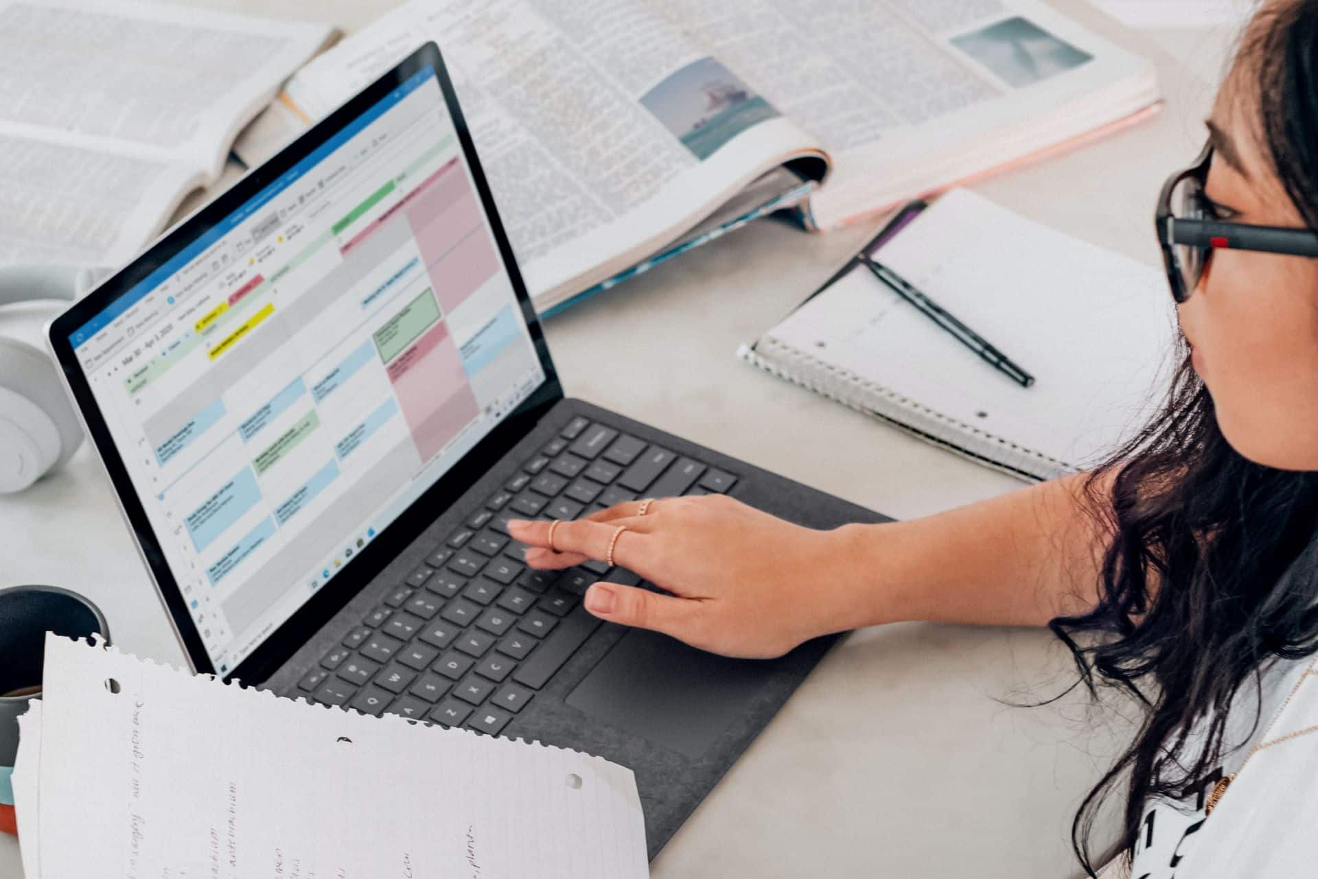 student at laptop with timetable and rubric