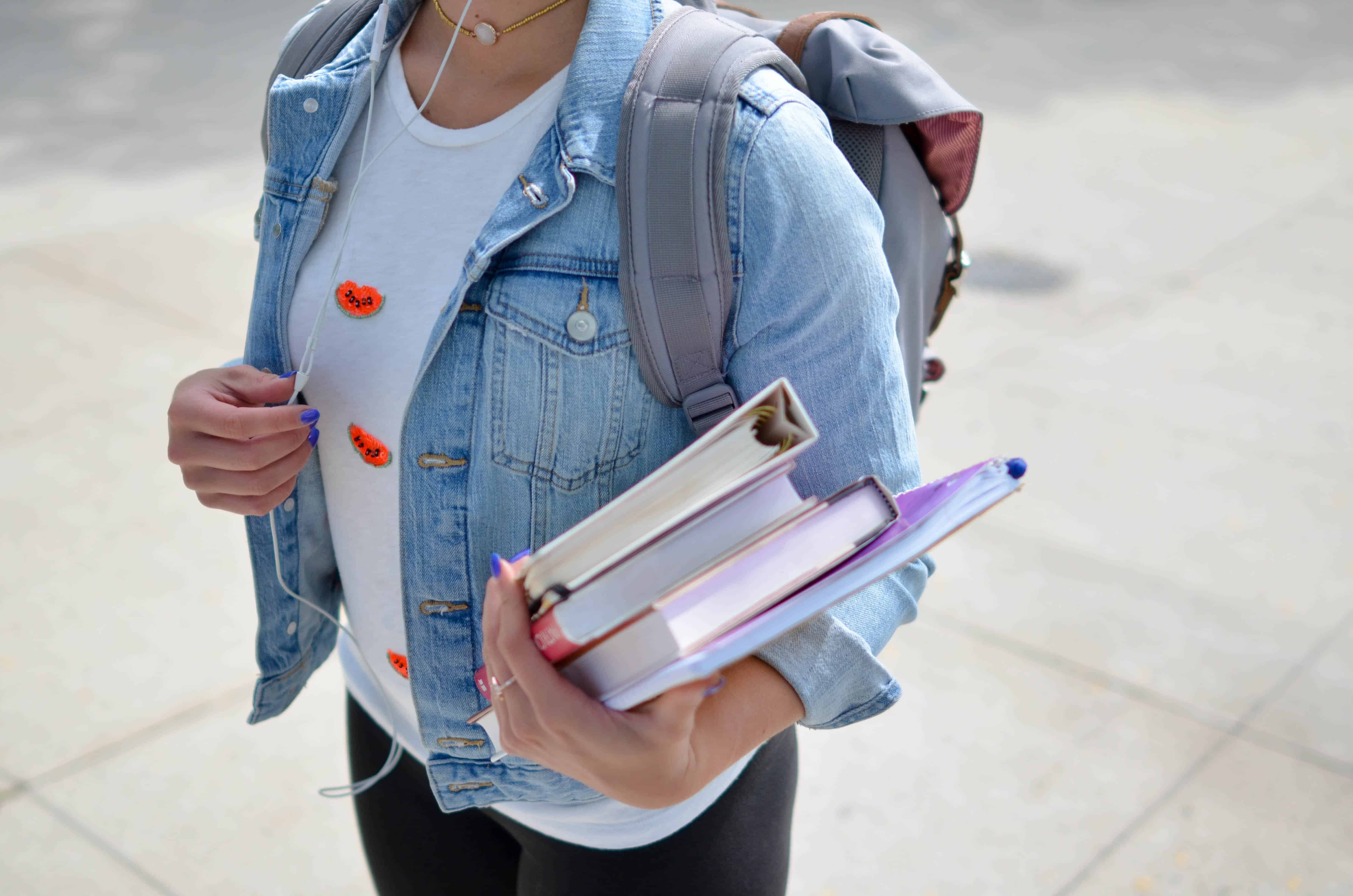 student with backpack and books