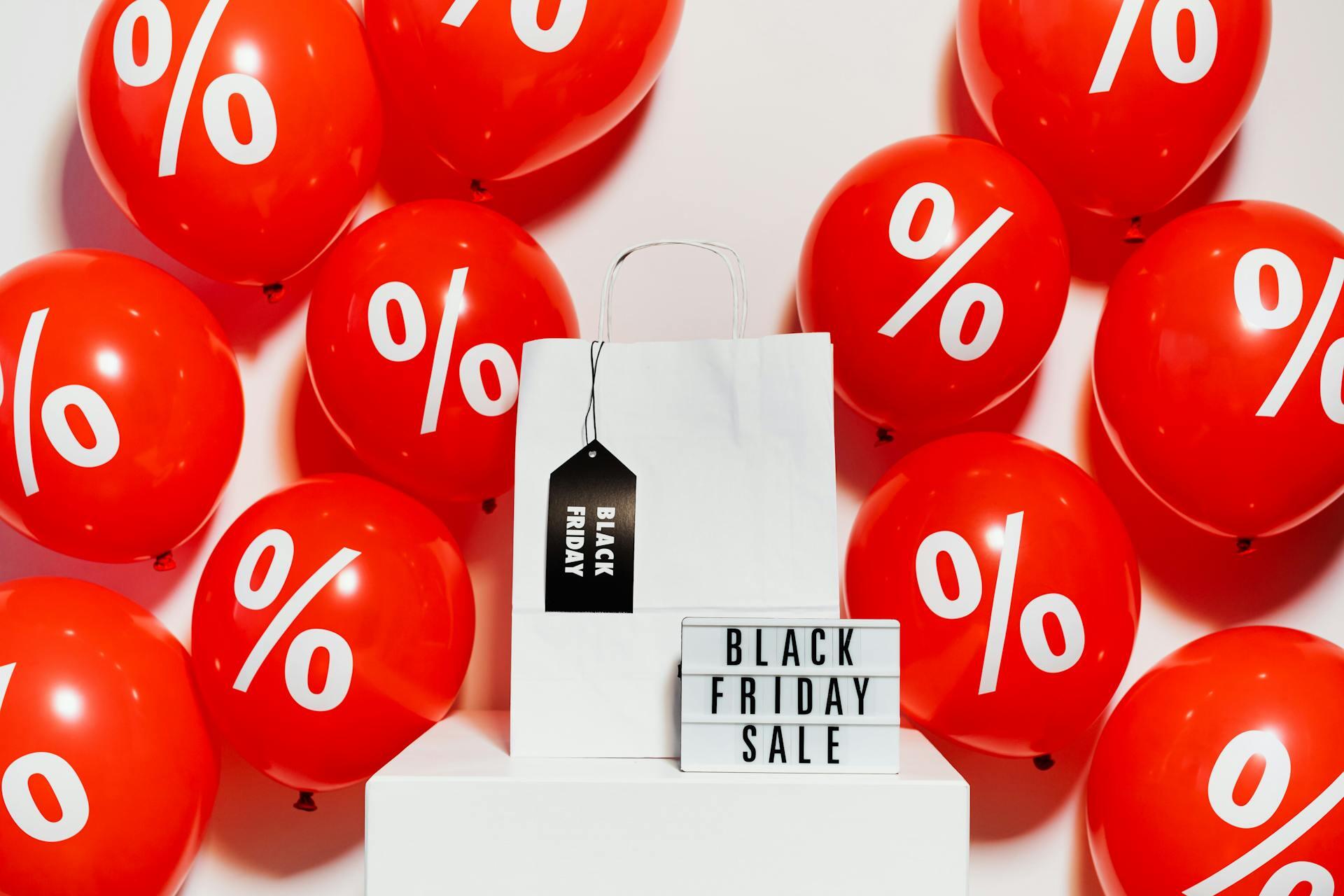 balloons and a sign advertising a black Friday sale