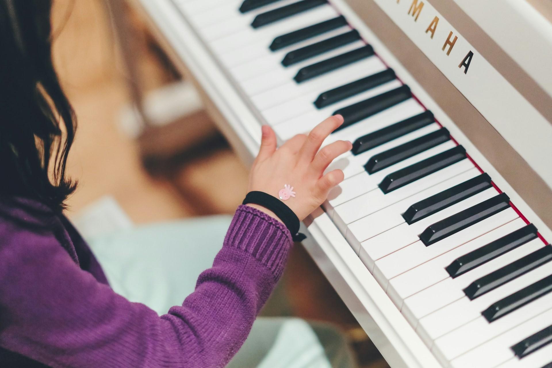 A girl playing a piano.