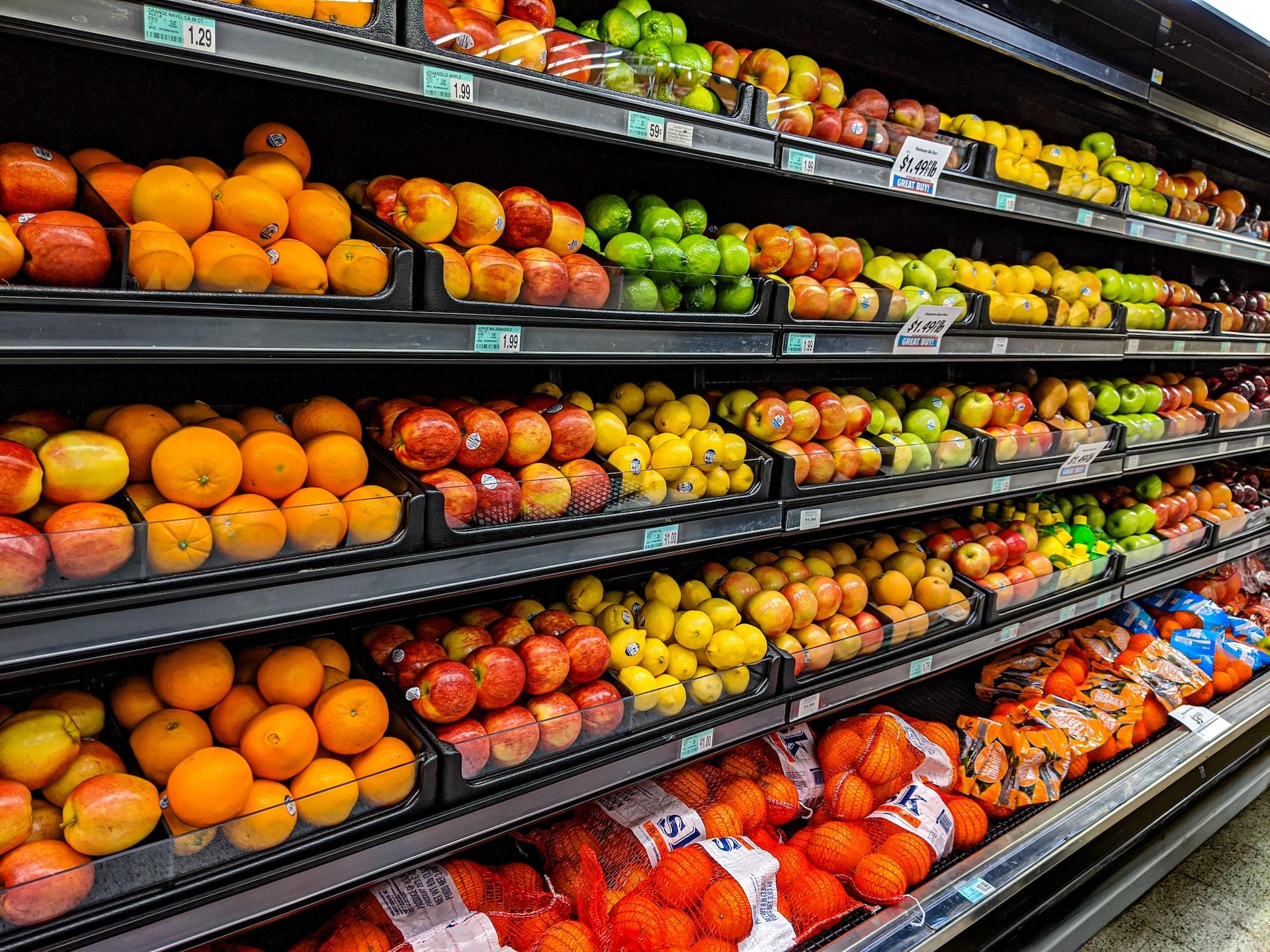Supermarket shelves with fruit on them