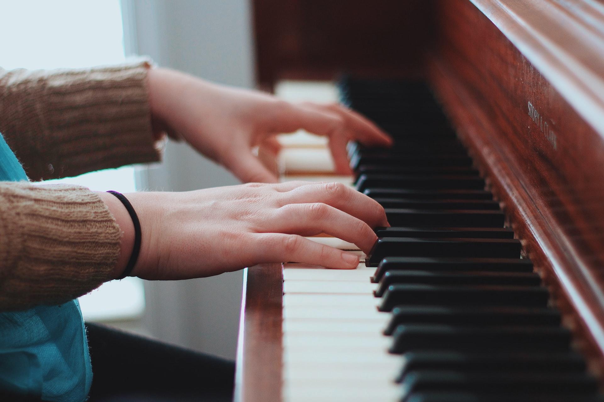 Closeup of hands playing the piano