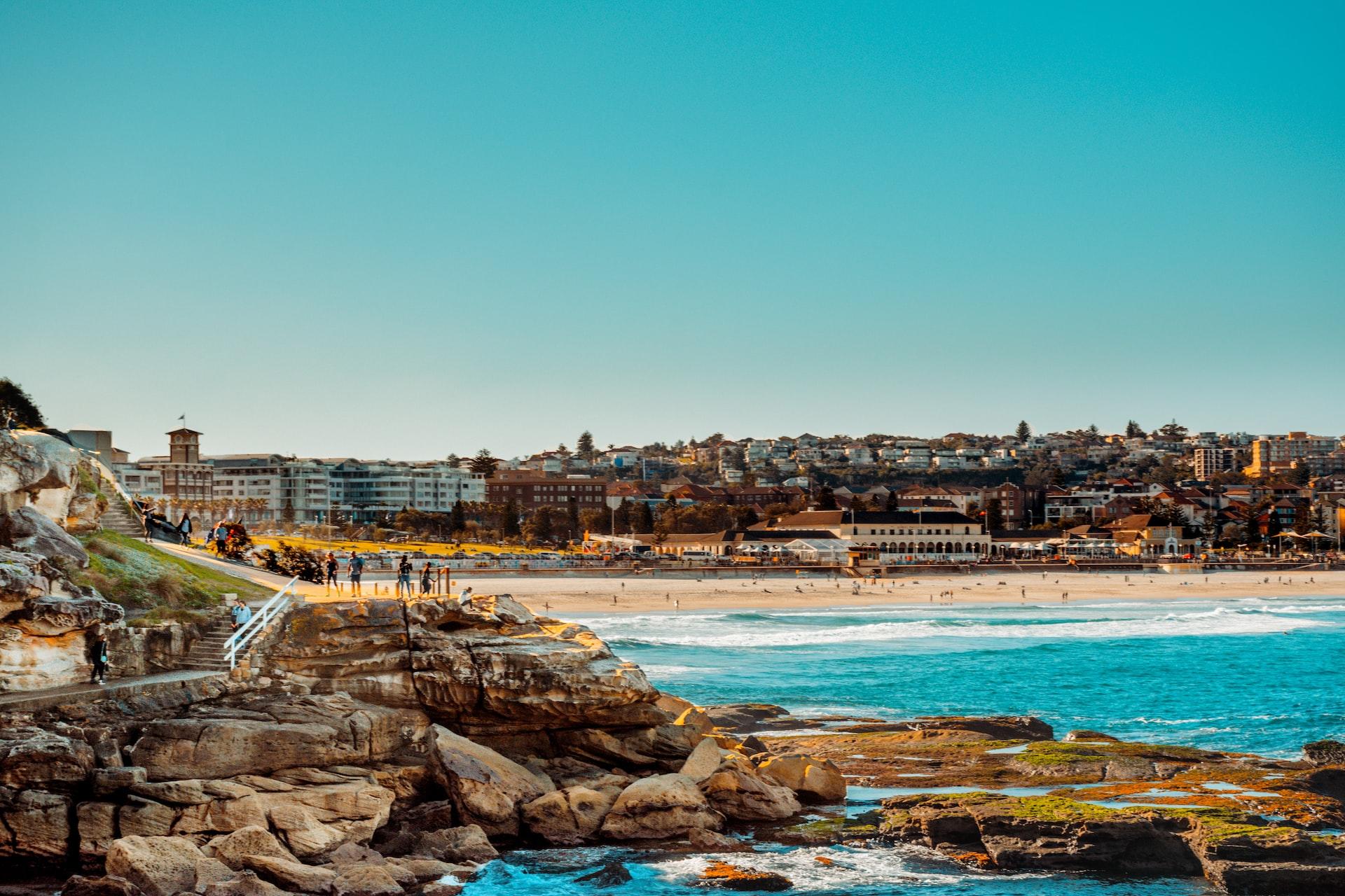 A panoramic shot of Bondi Beach on a clear and sunny day. 