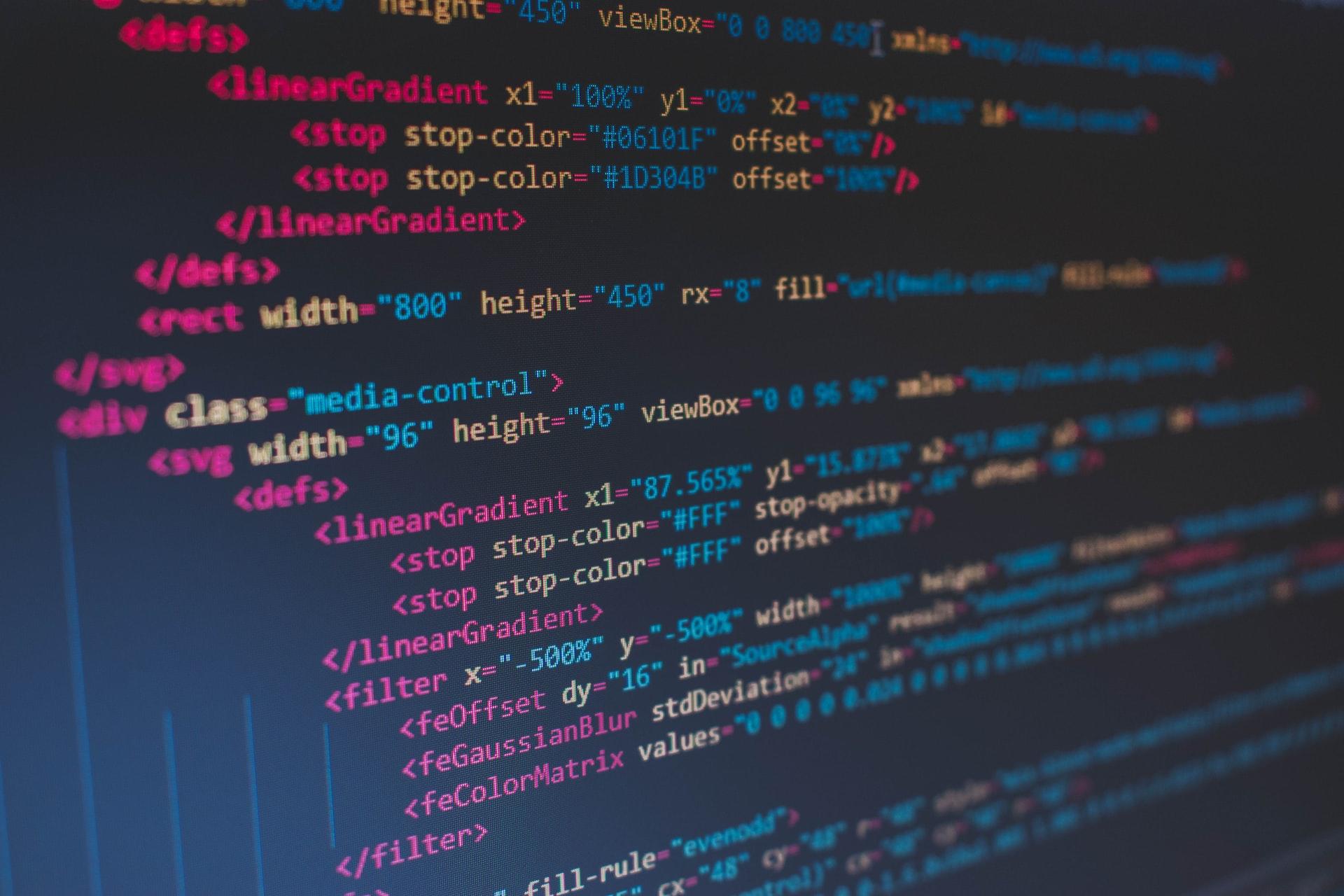 A computer screen displaying lines of code written in many different colours and with many indentations.