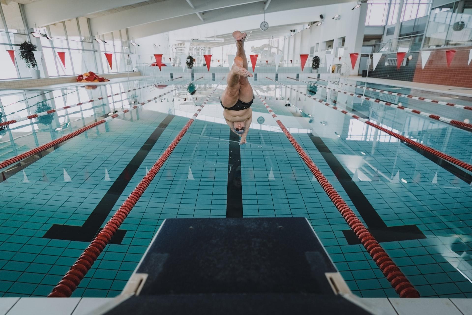Person diving into a swimming pool