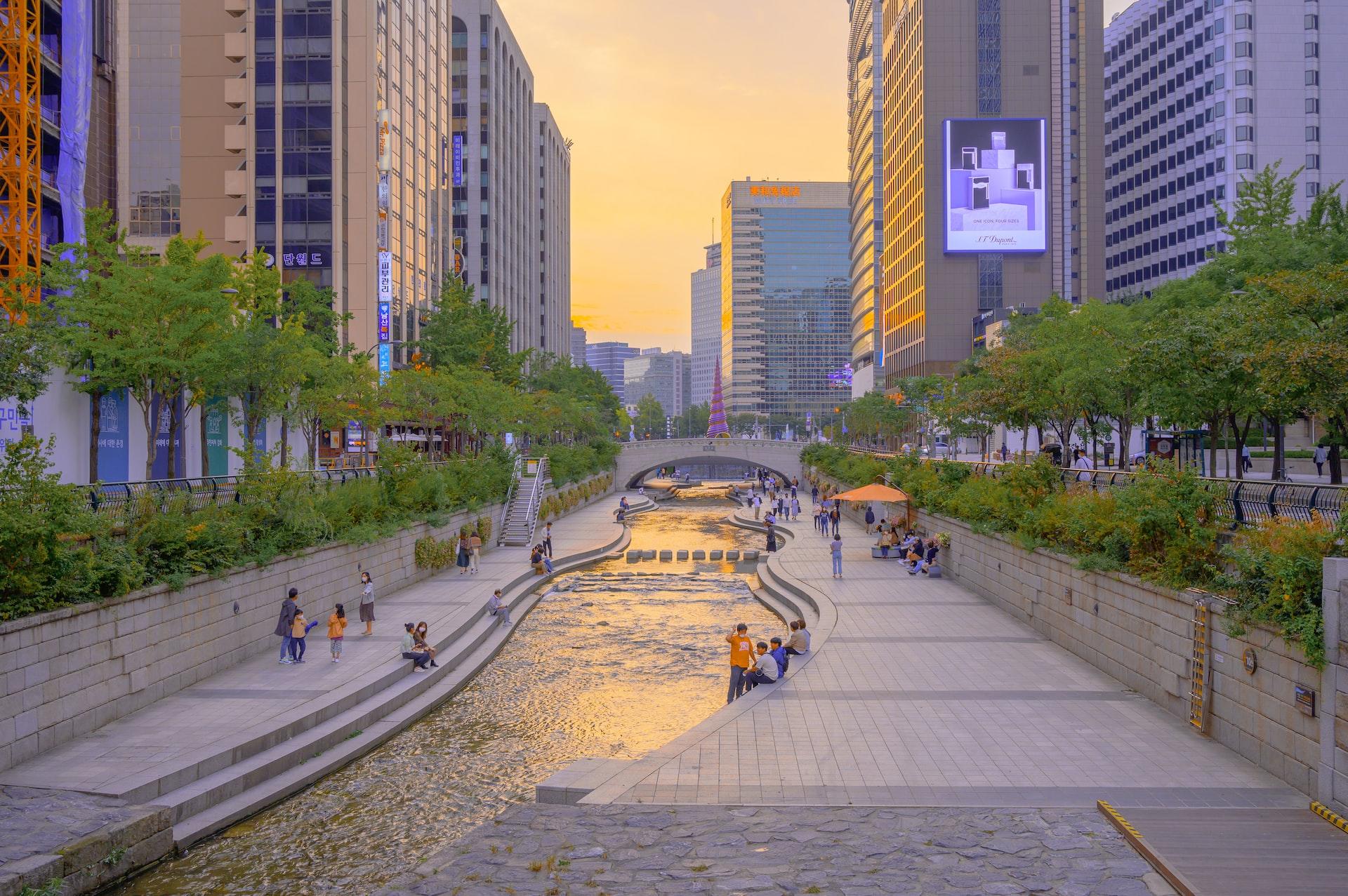 People walking by a waterway in Seoul, South Korea