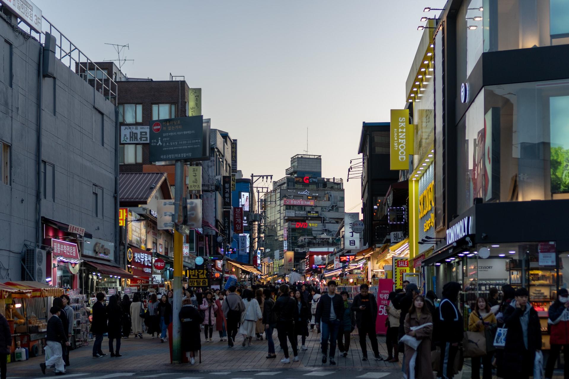 A South Korean street with market stalls and shops