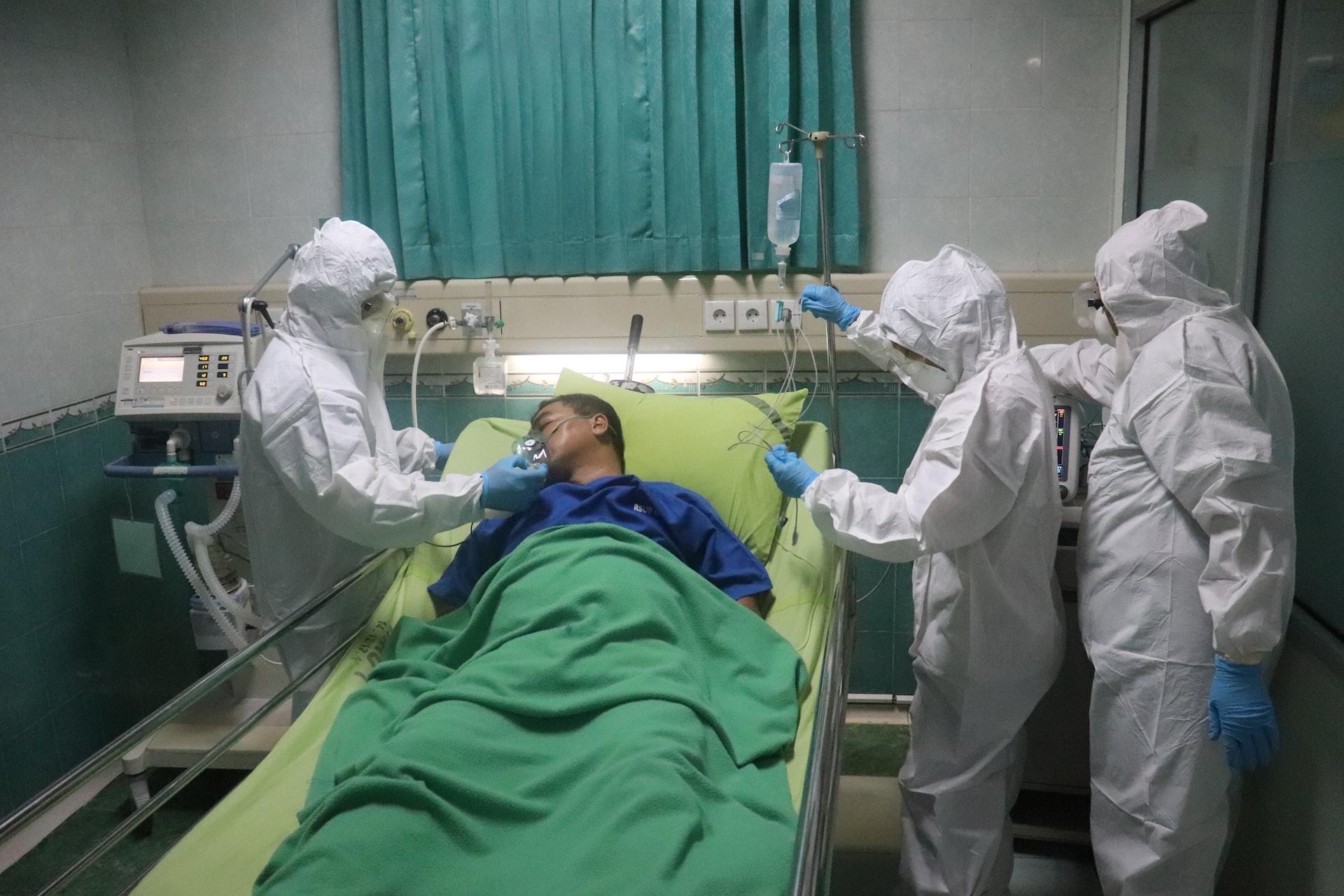 Medical professionals surrounding a sick patient