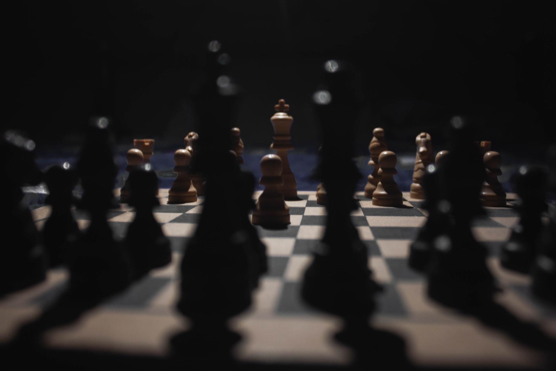 A chess board in low light.