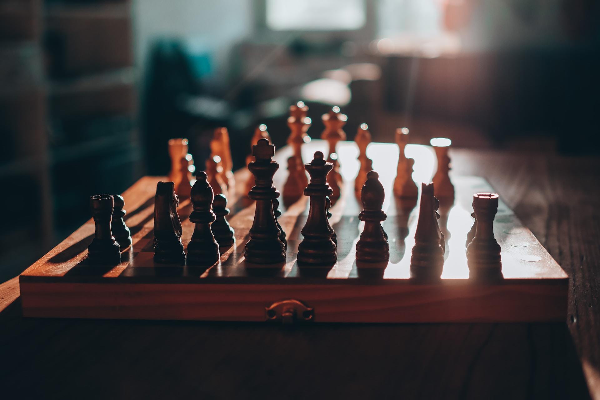 A view of a chess board in the sunlight at somebody's home.