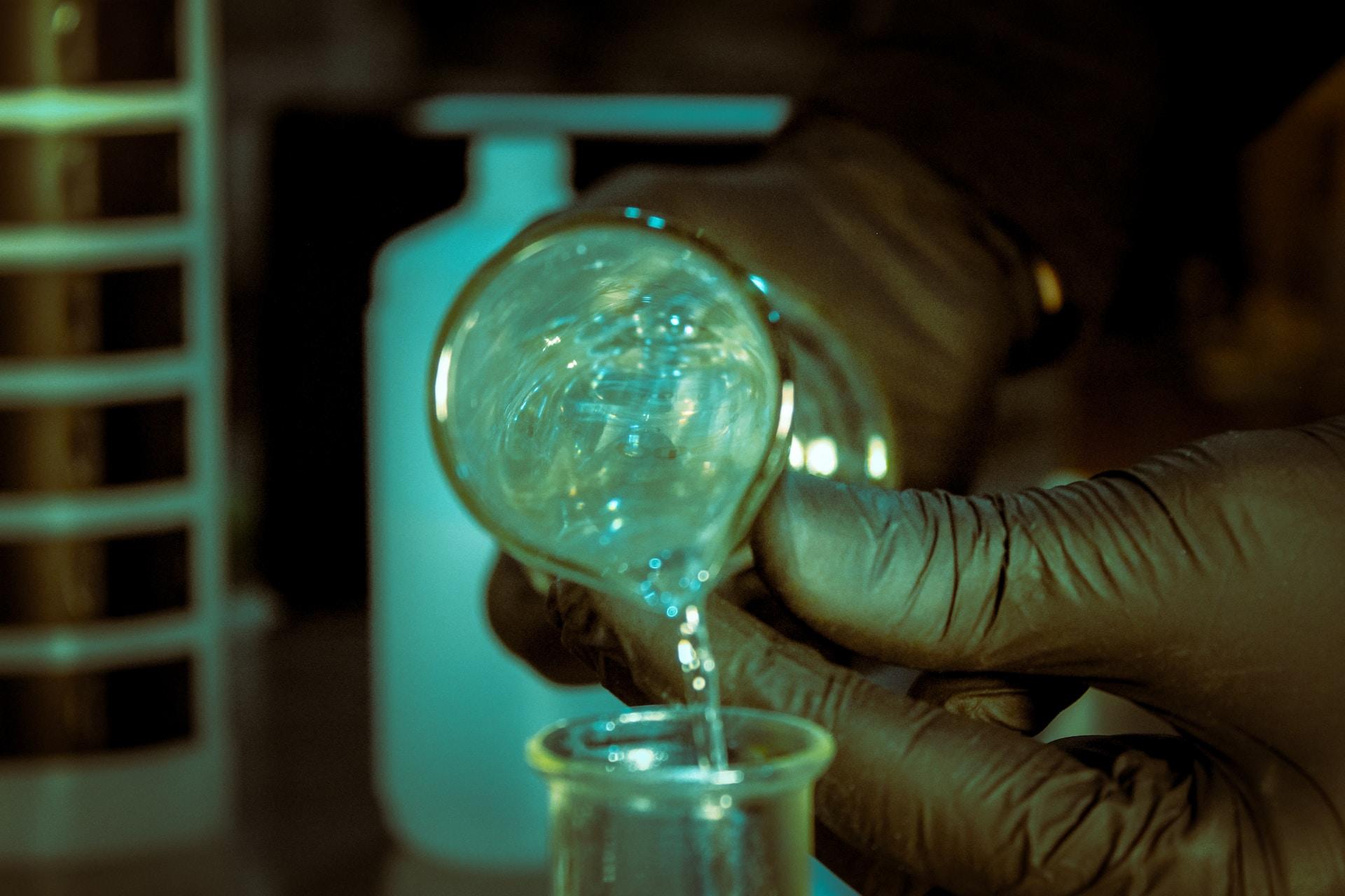 A liquid being poured from one container to another.