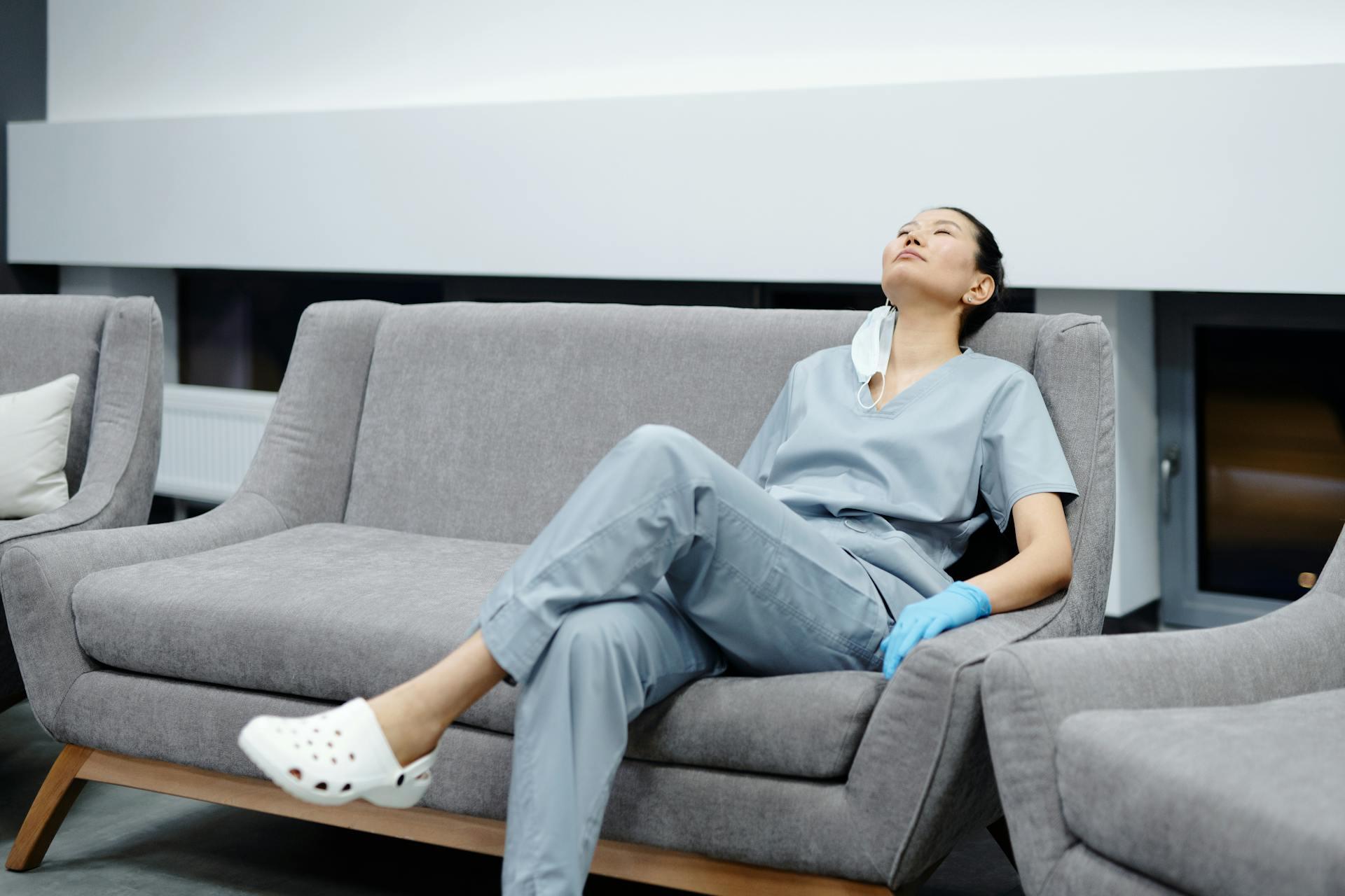Tired nurse resting on a couch