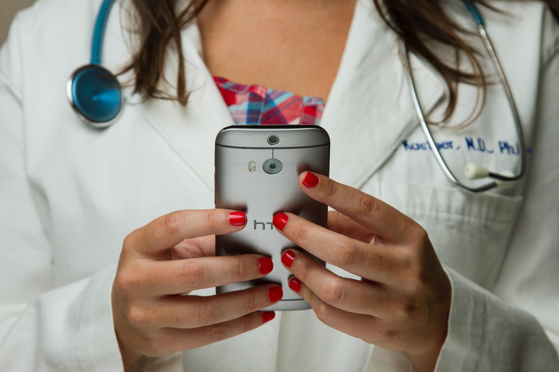 A doctor holding a mobile phone.