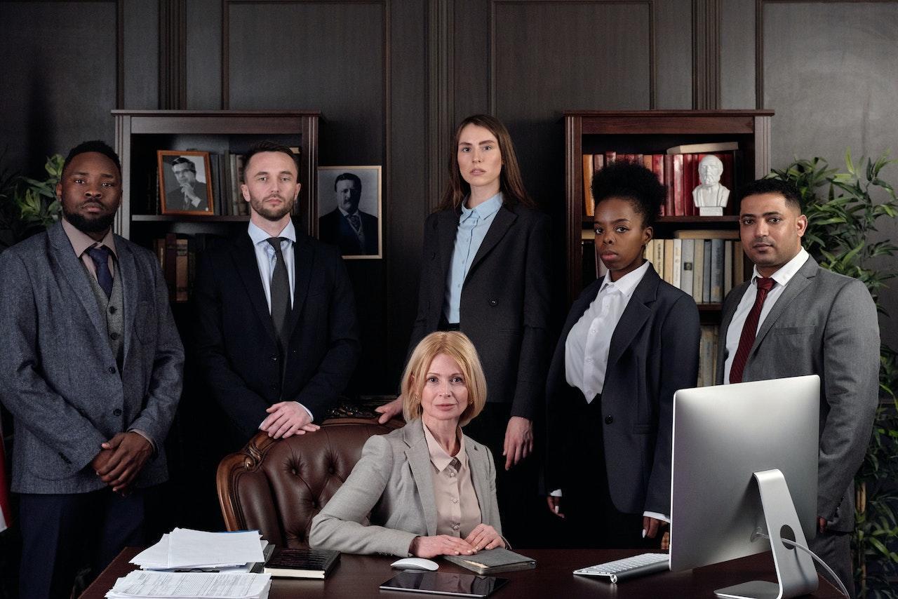 A group of lawyers who work in the same firm posing together.
