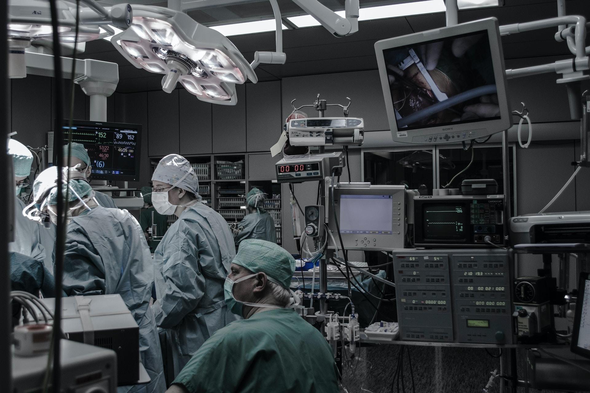 A group of medical professionals in a surgical theatre.