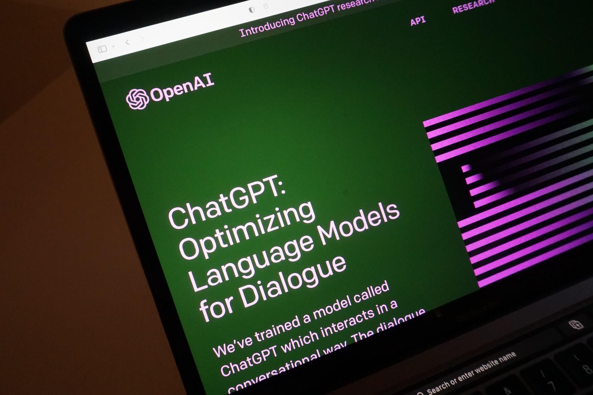 A laptop screen with the OpenAI and ChatGPT homescreen on it.
