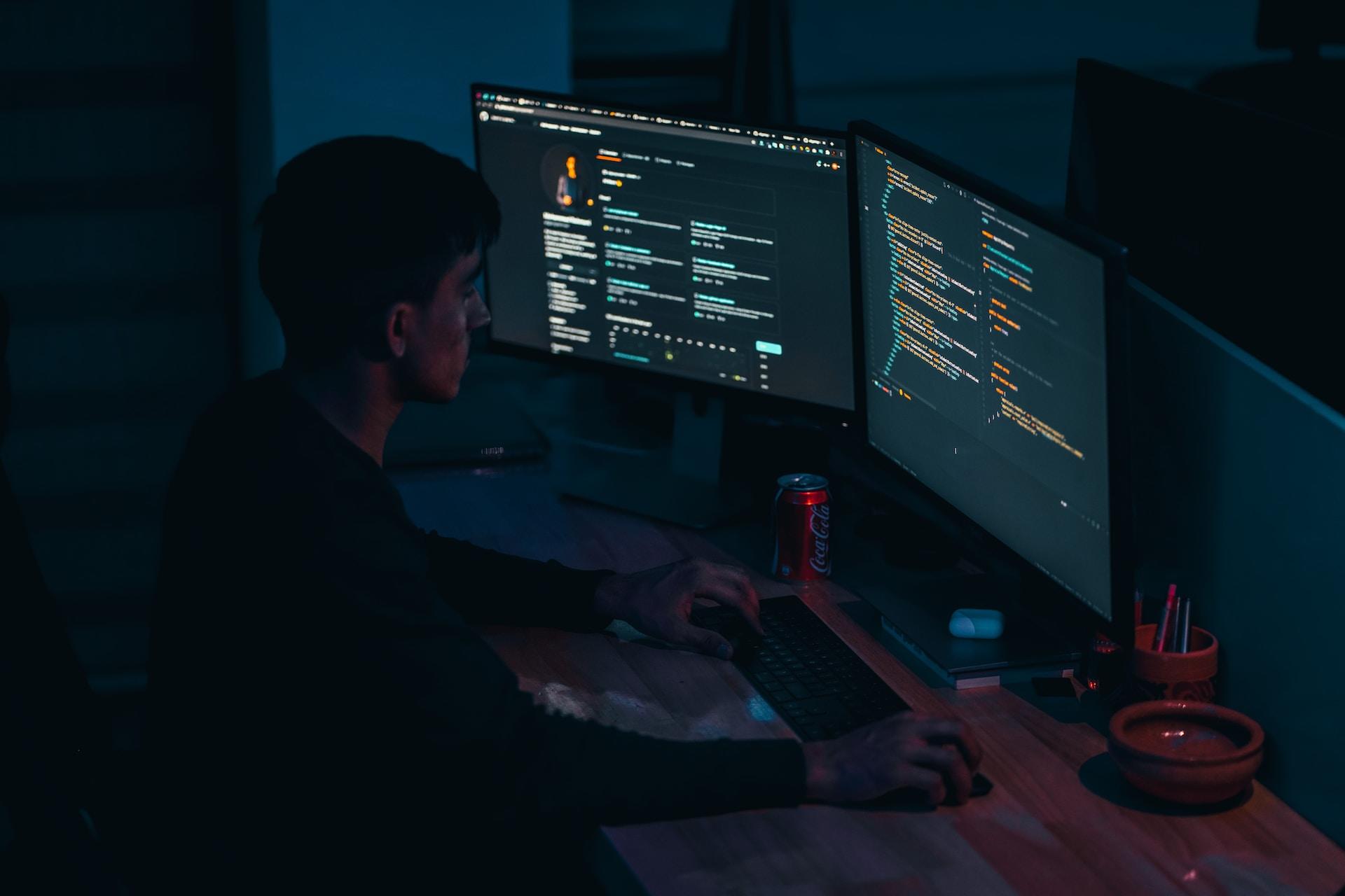 A man working with code on a computer.