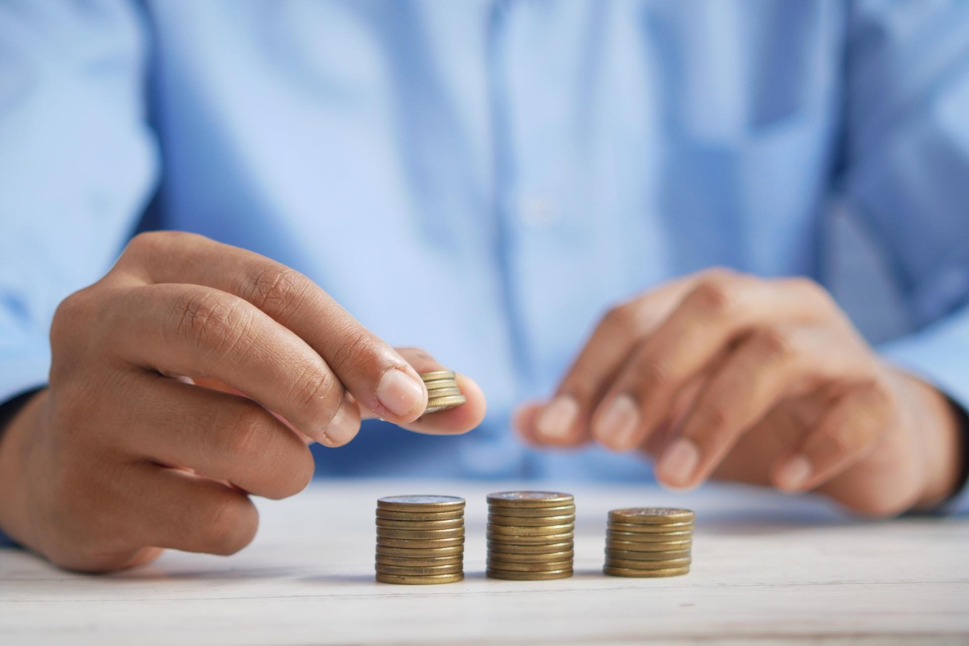 A person stacking coins.