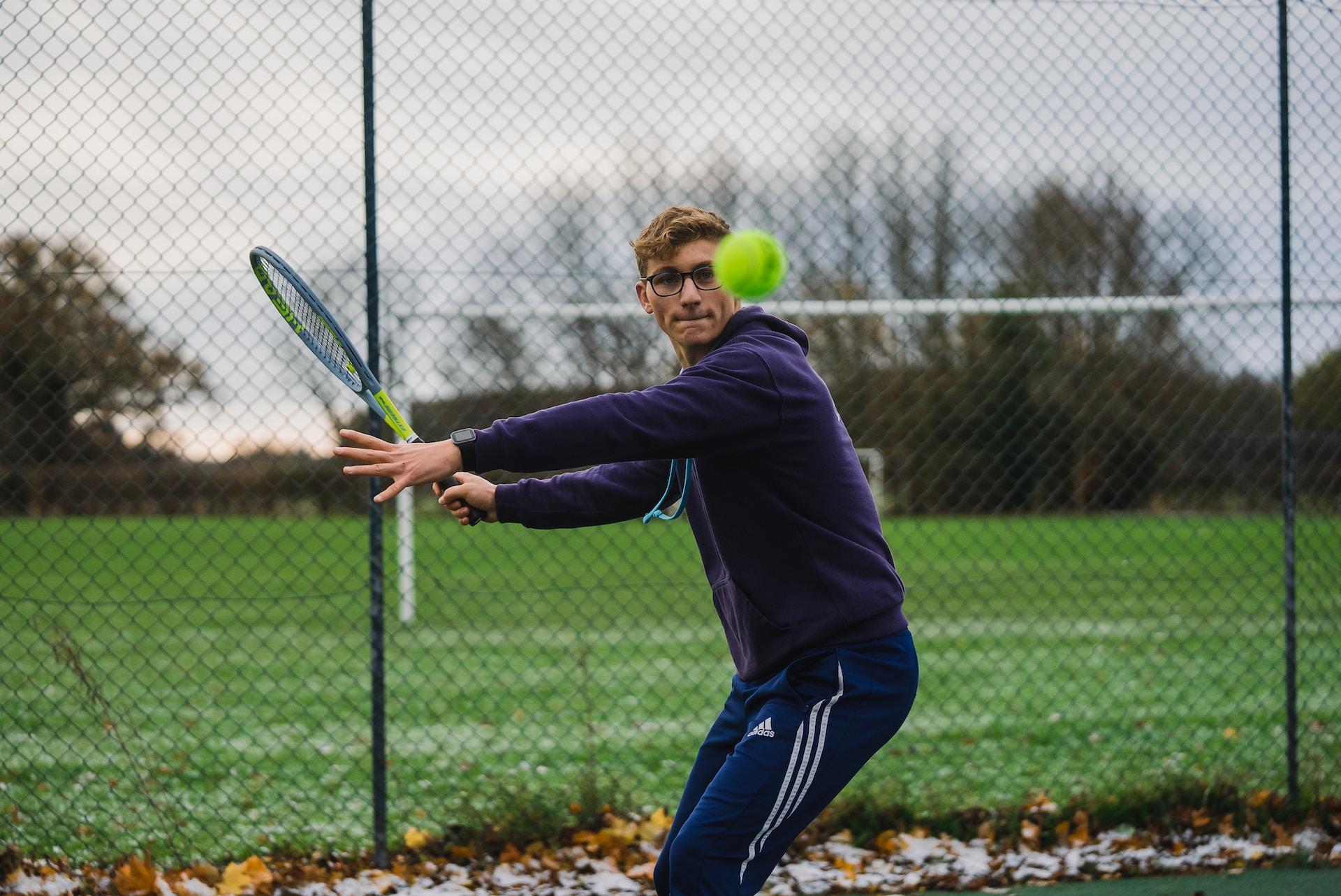 A tennis player returning a shot.