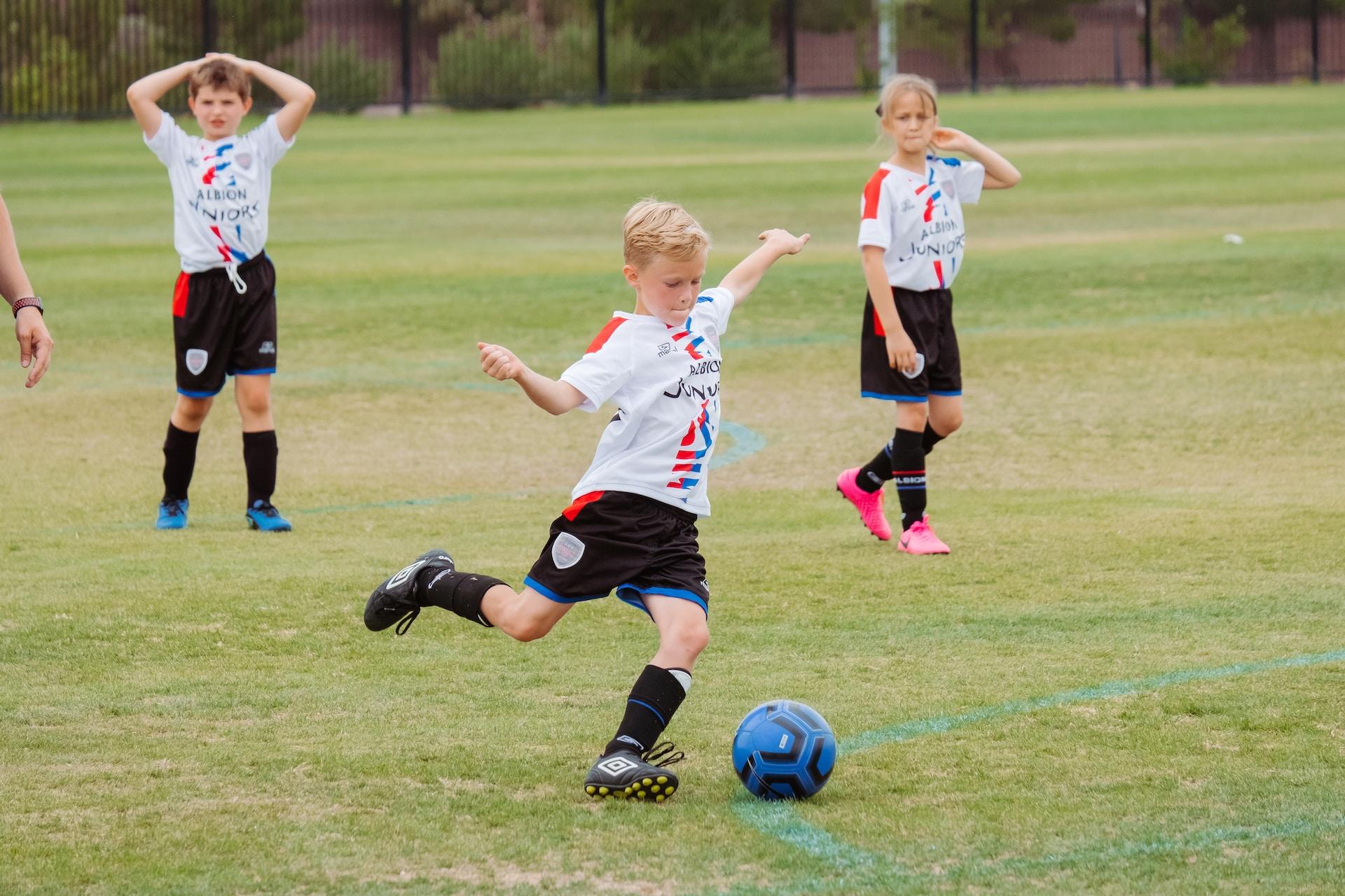 Kids playing soccer.