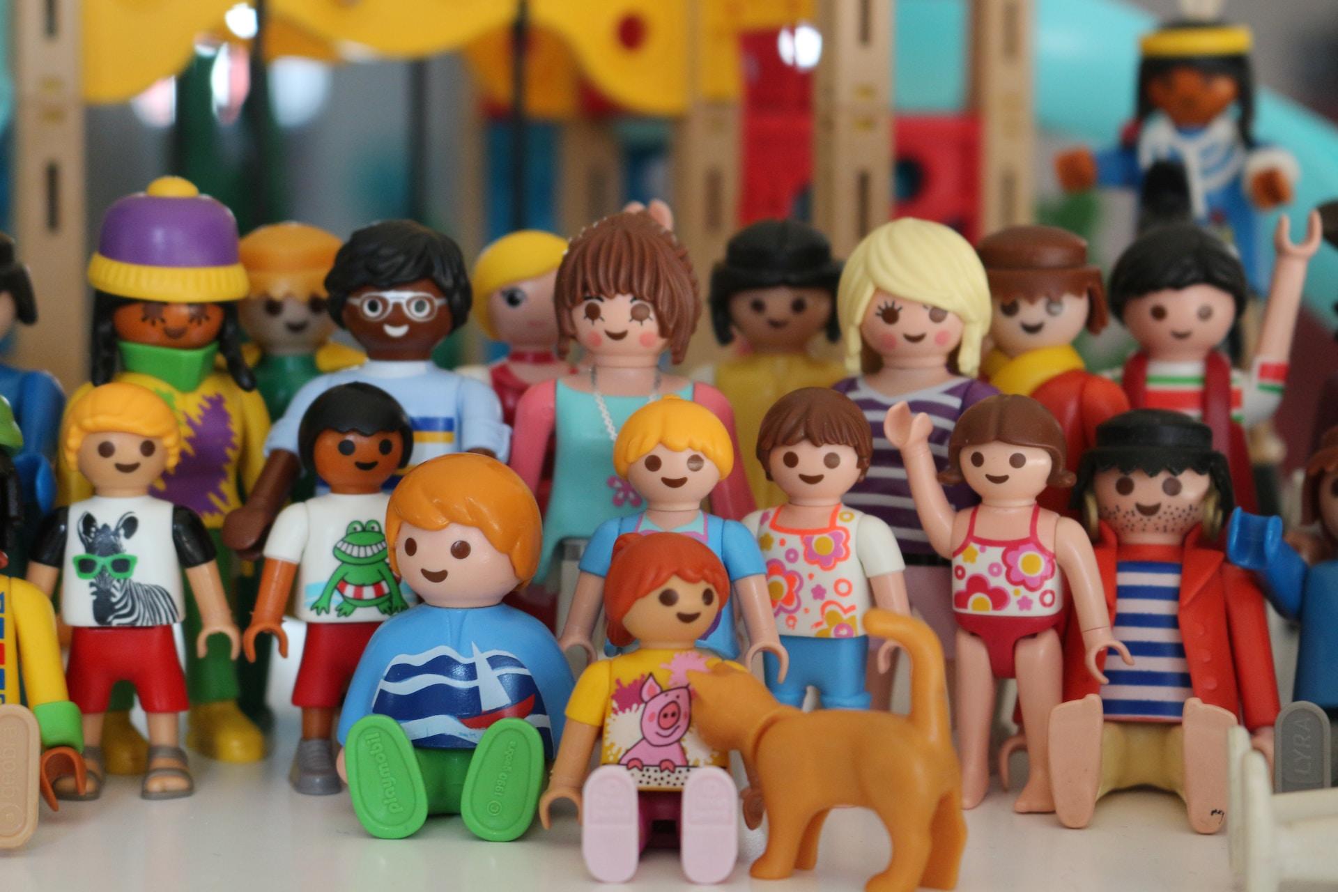 An array of colourful dolls with varying clothes and skin tones.