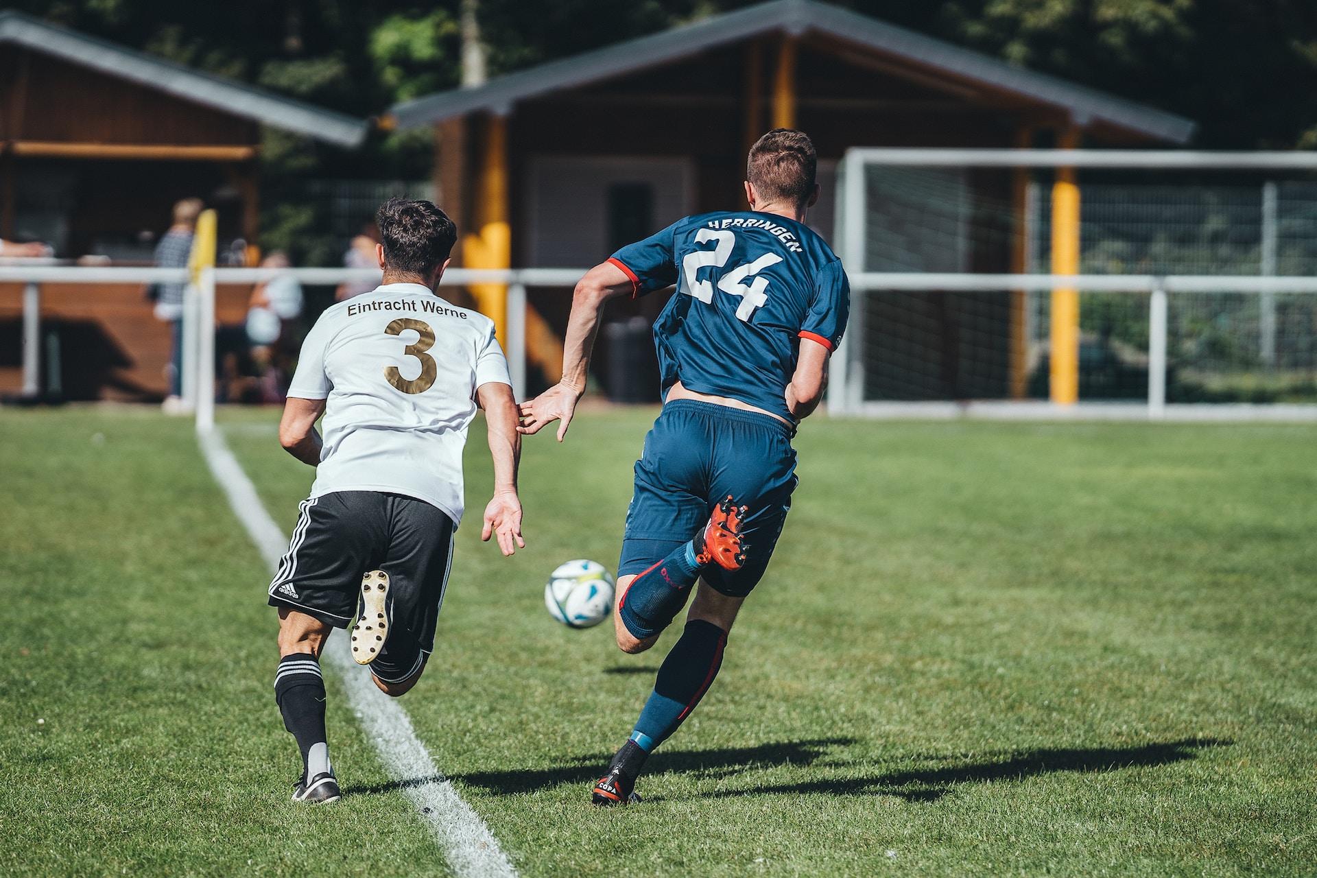 Soccer players running down the wing.