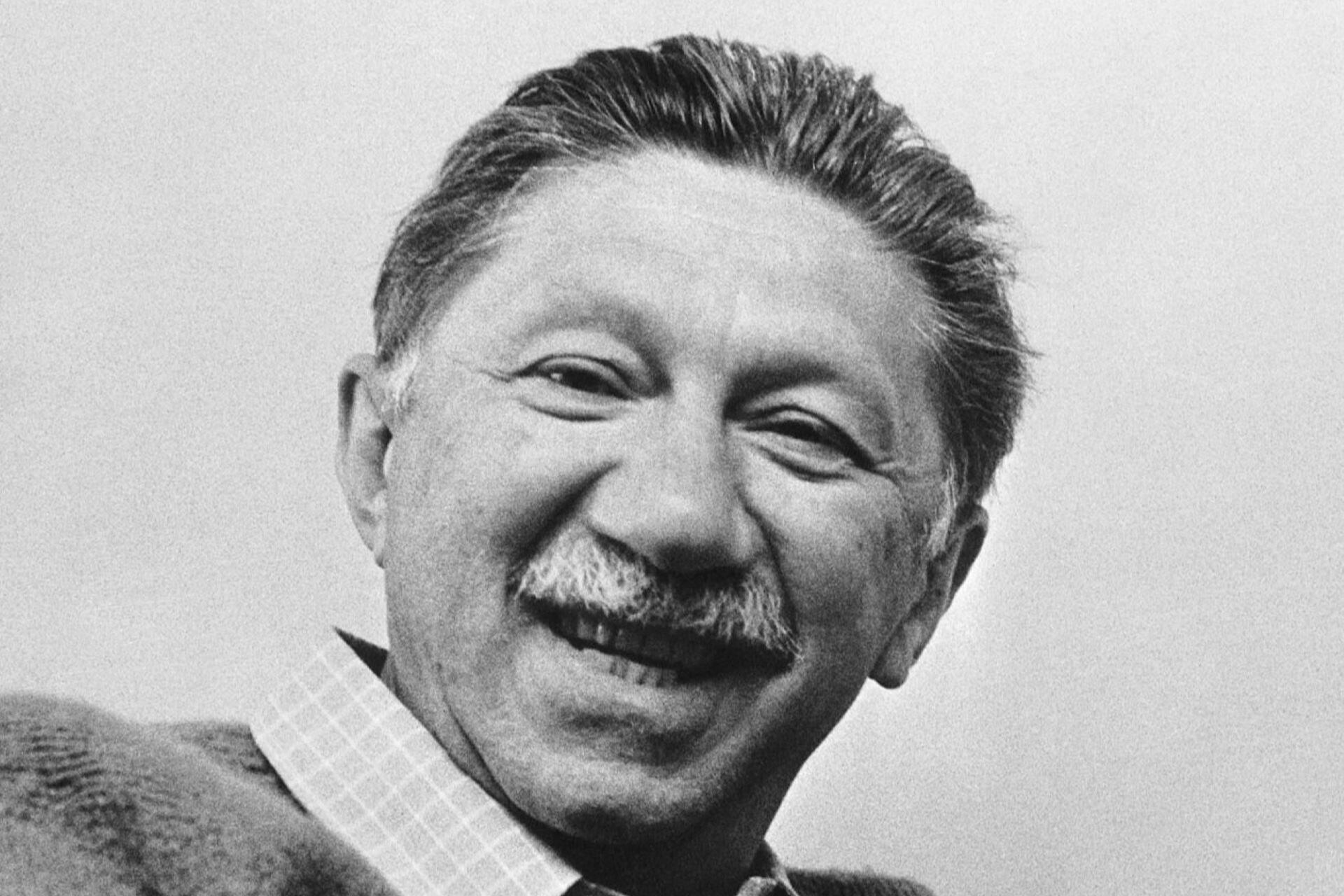 Black and white portrait of an older male psychologist (Abraham Maslow) smiling toward the camera