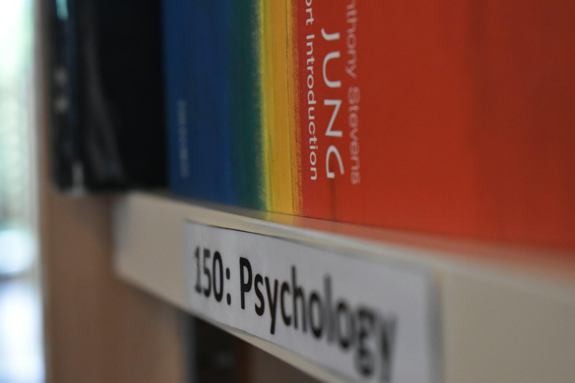 Close-up of psychology books arranged on a library shelf