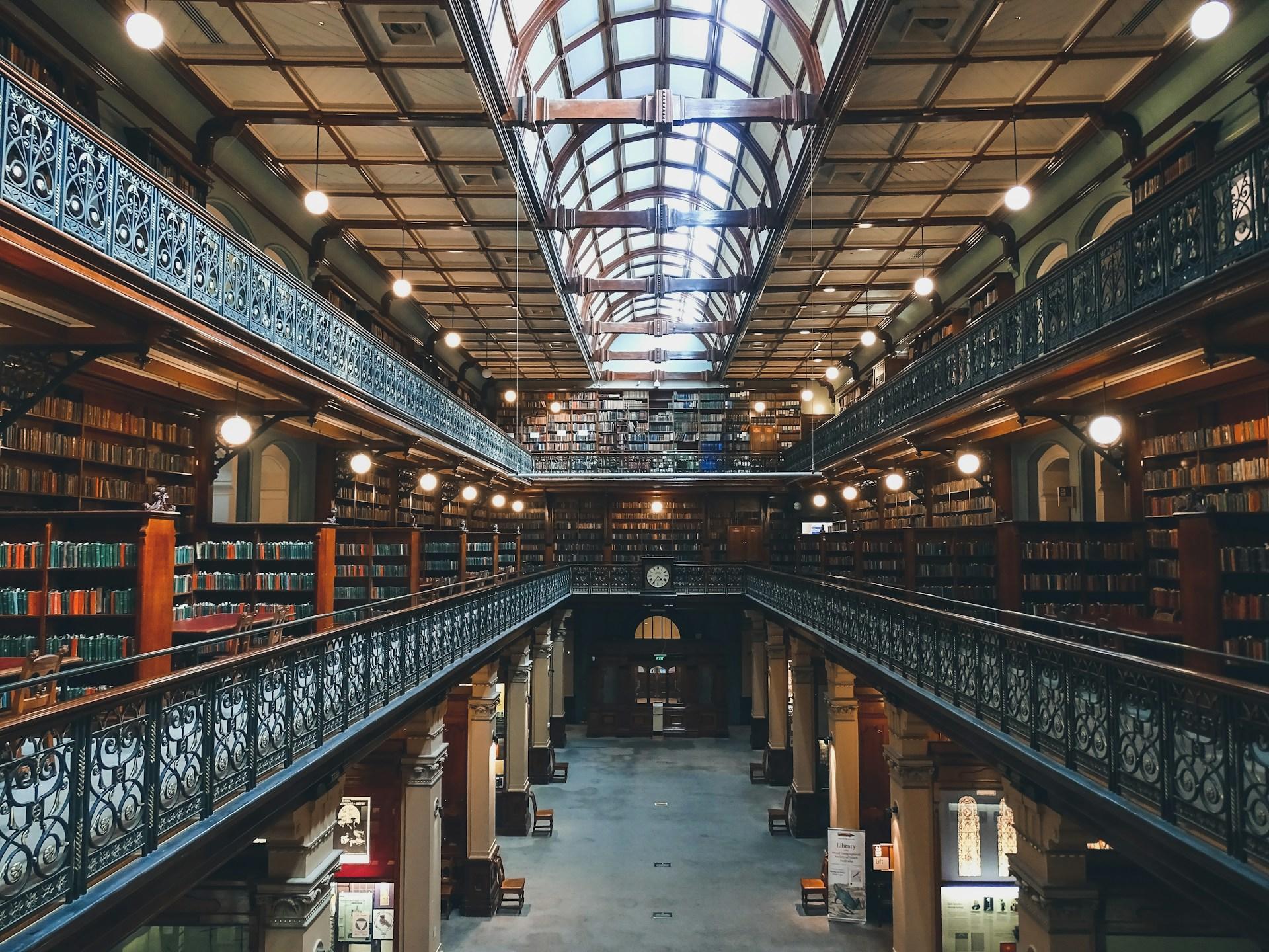 A library with three levels and a glass panel roof.