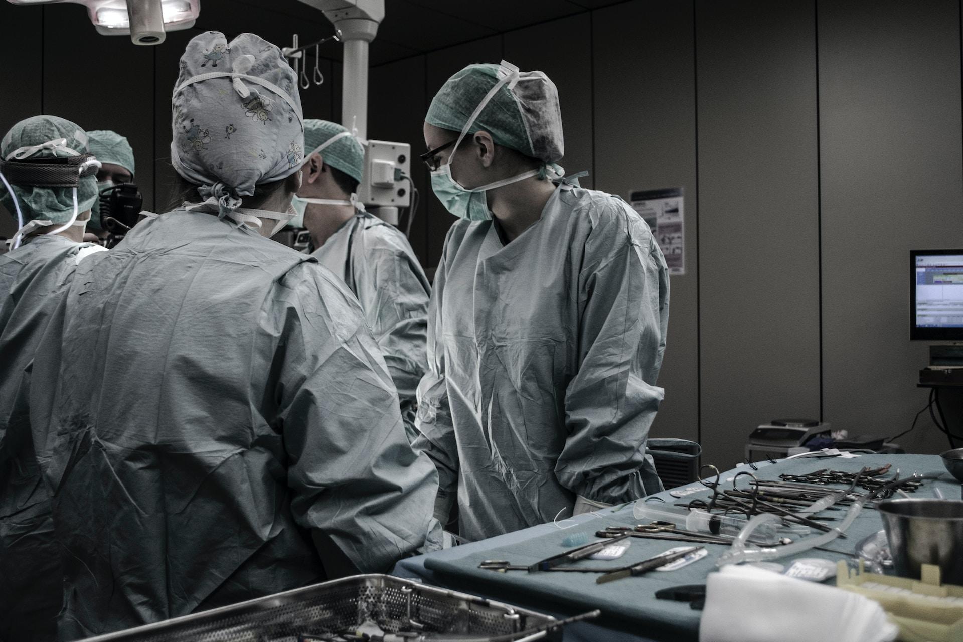 Several surgeons working in an operating theatre.