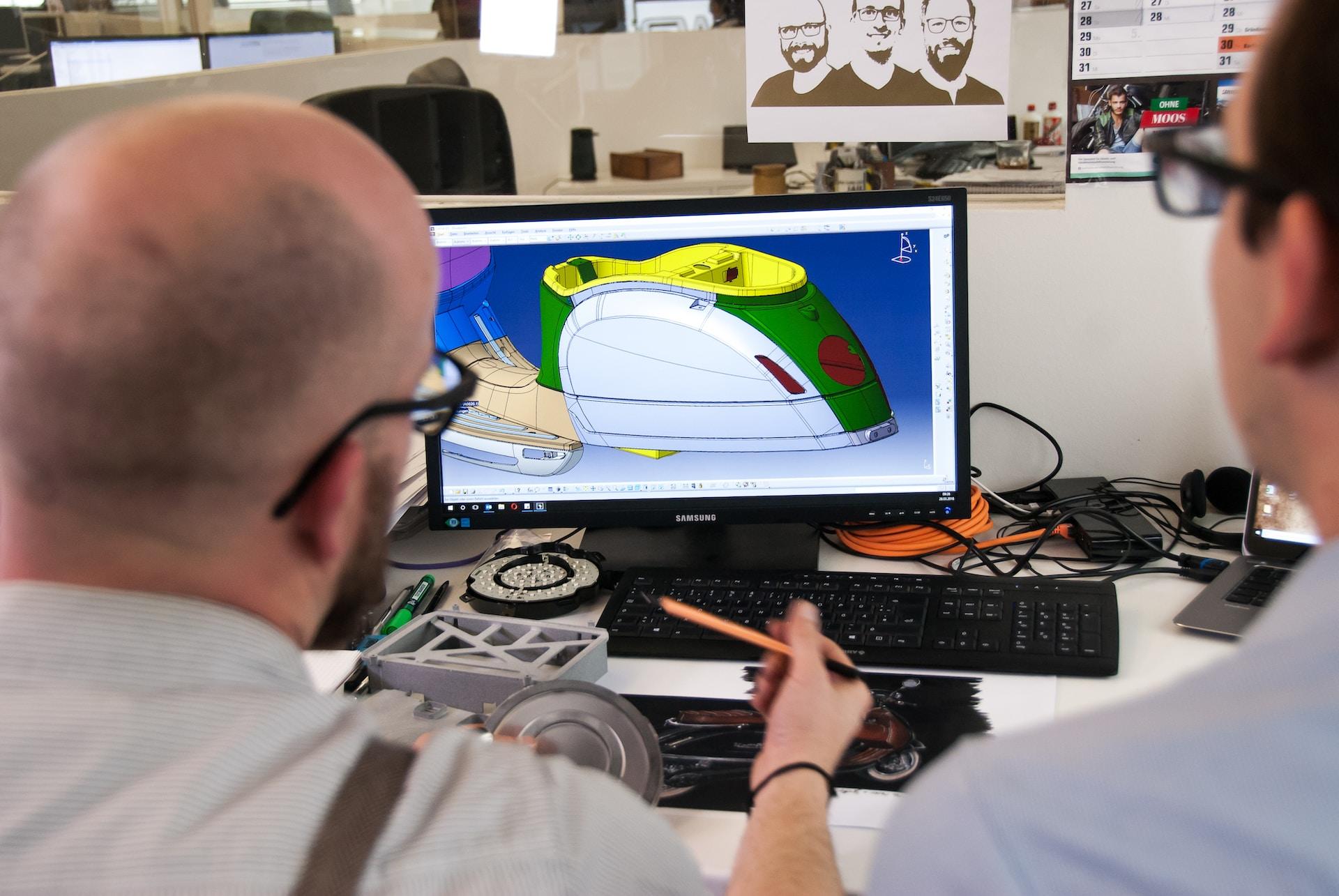 Two people using CAD to design a product.