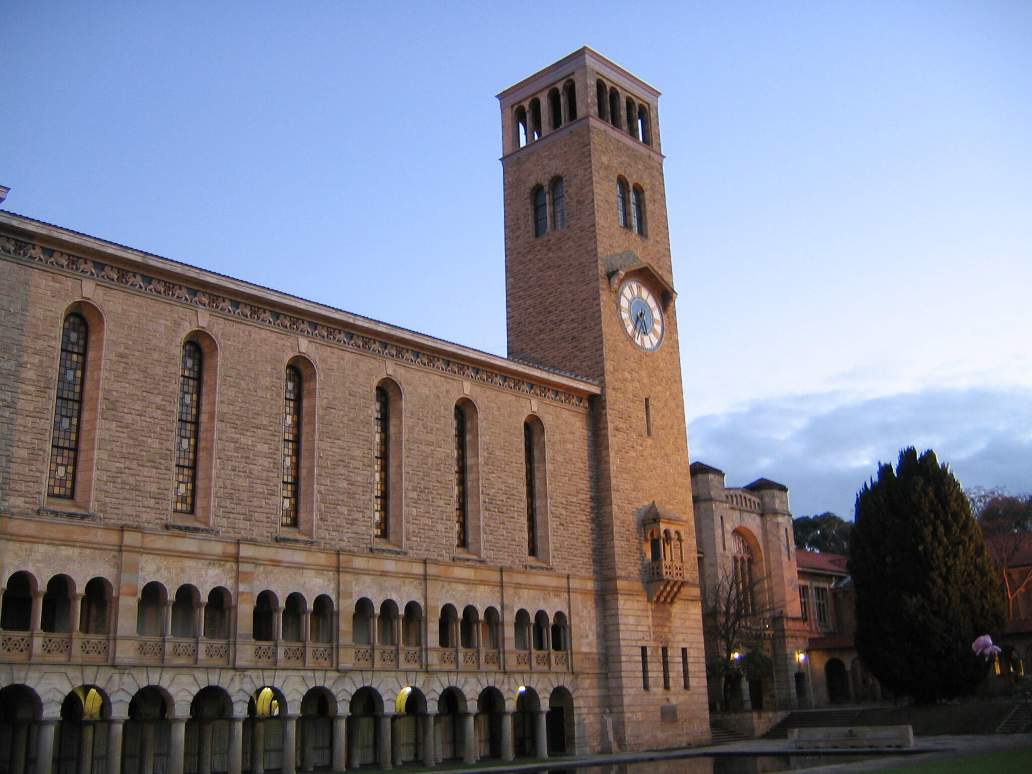 A large stone building with a tower on a clear day.