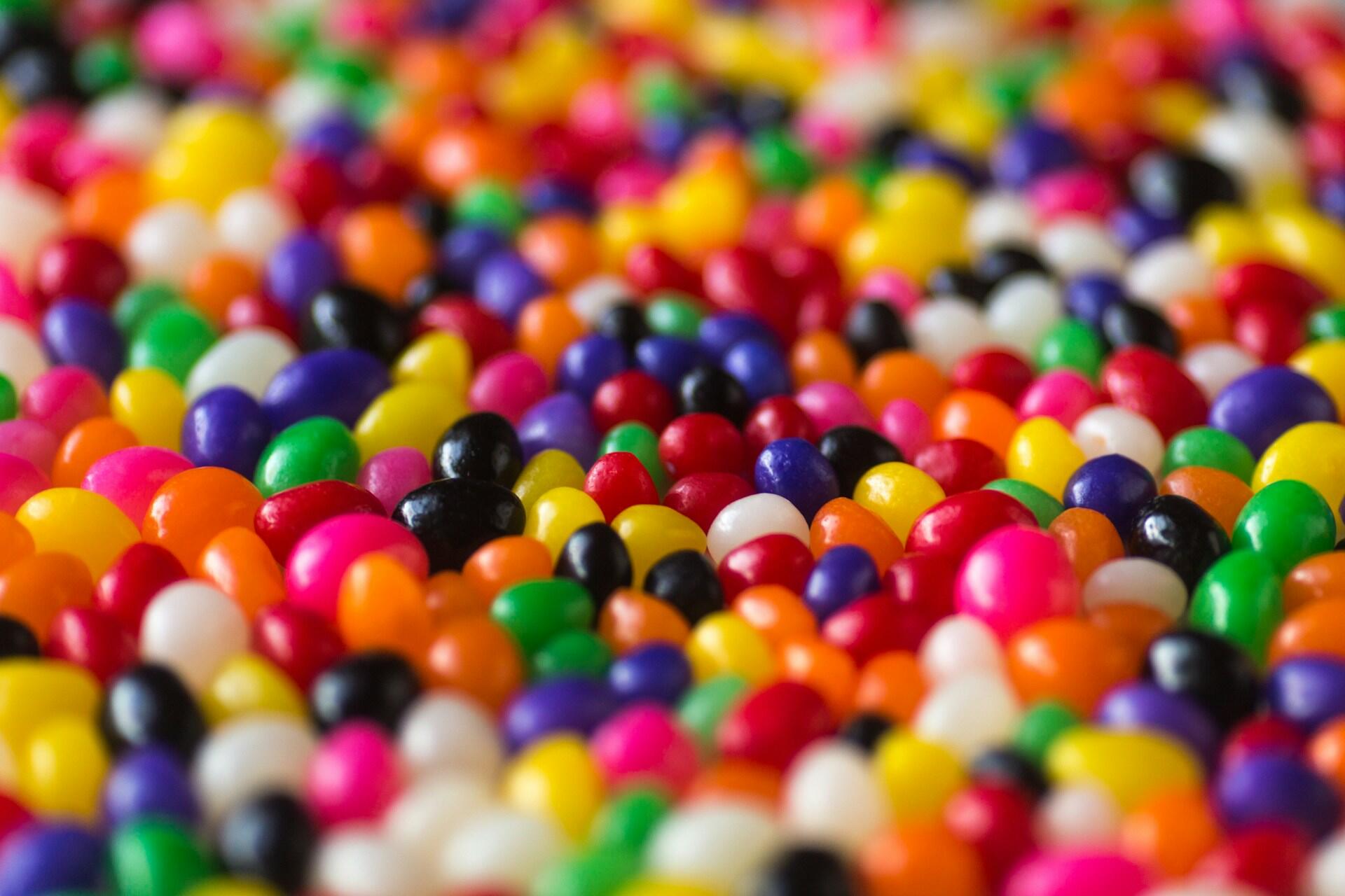 Close up of multicoloured round sweets scattered together