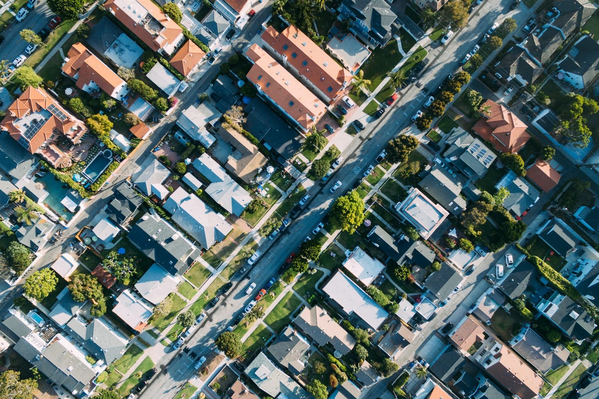 aerial view of residential neighbourhood with houses, streets, and parked cars