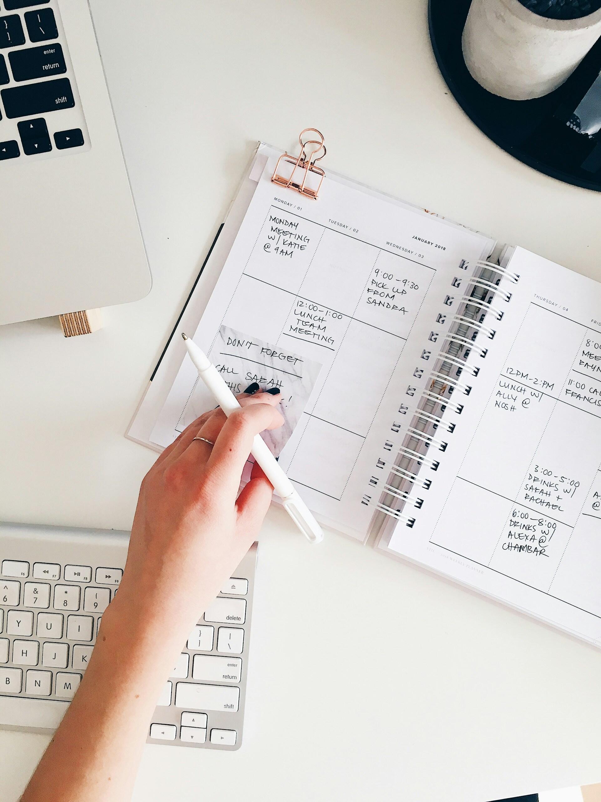 A person planning an event in a diary.