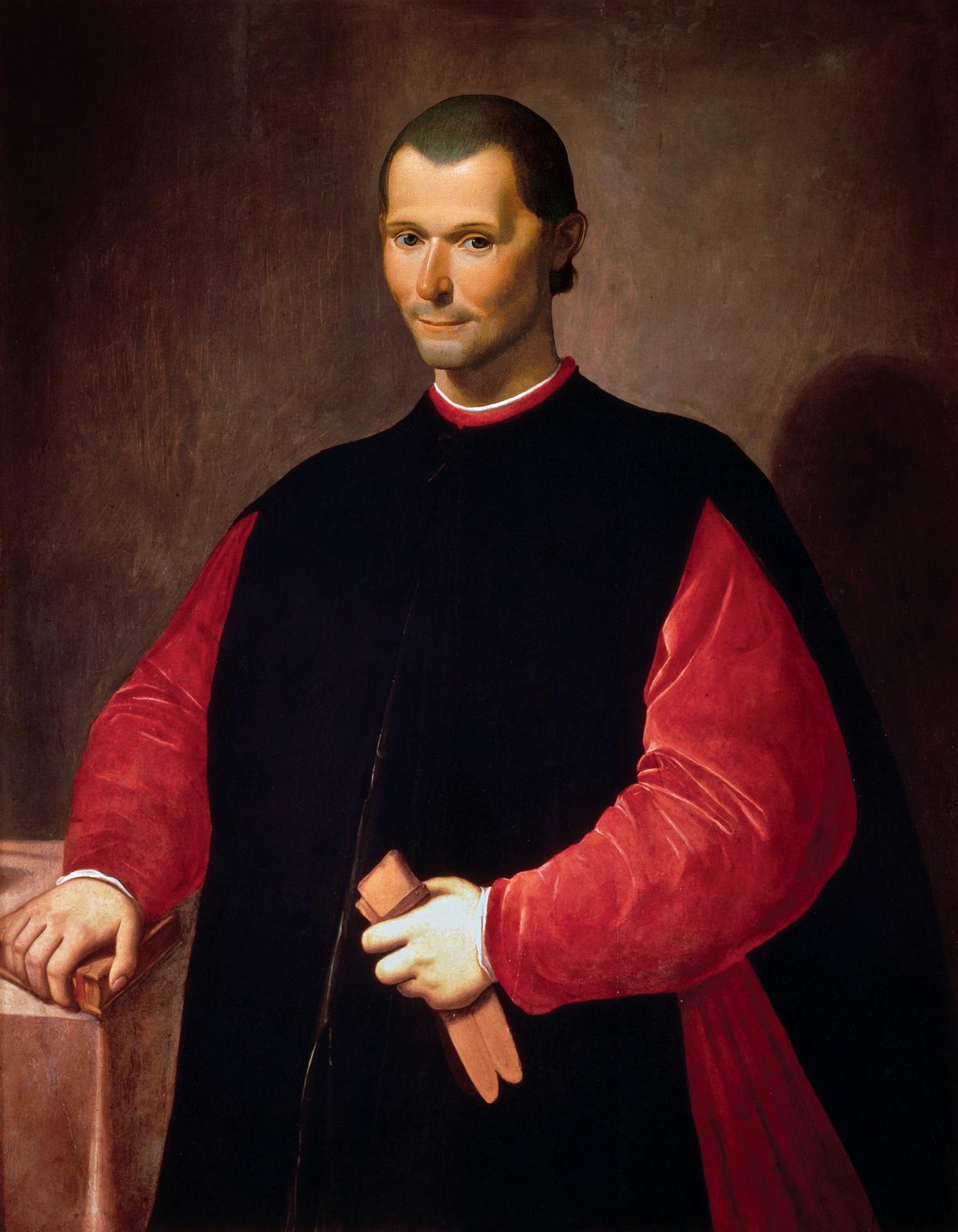 A painting of Niccolo Machiavelli, dressed in a red robe overlayed with a black cloak, holding a pair of pale pink gloves in his left hand, with his right hand resting on a book.  