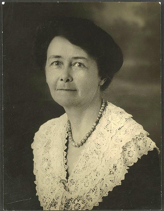 Vintage portrait of a woman in a hat and lace collar.