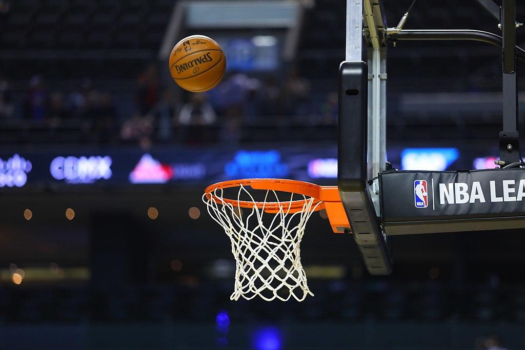 A basketball is flying towards the hoop.