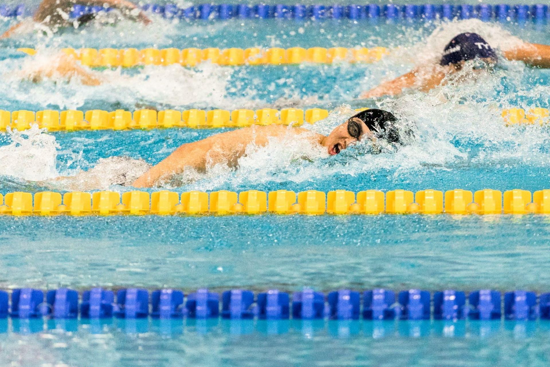 A swimmer racing in a lane.