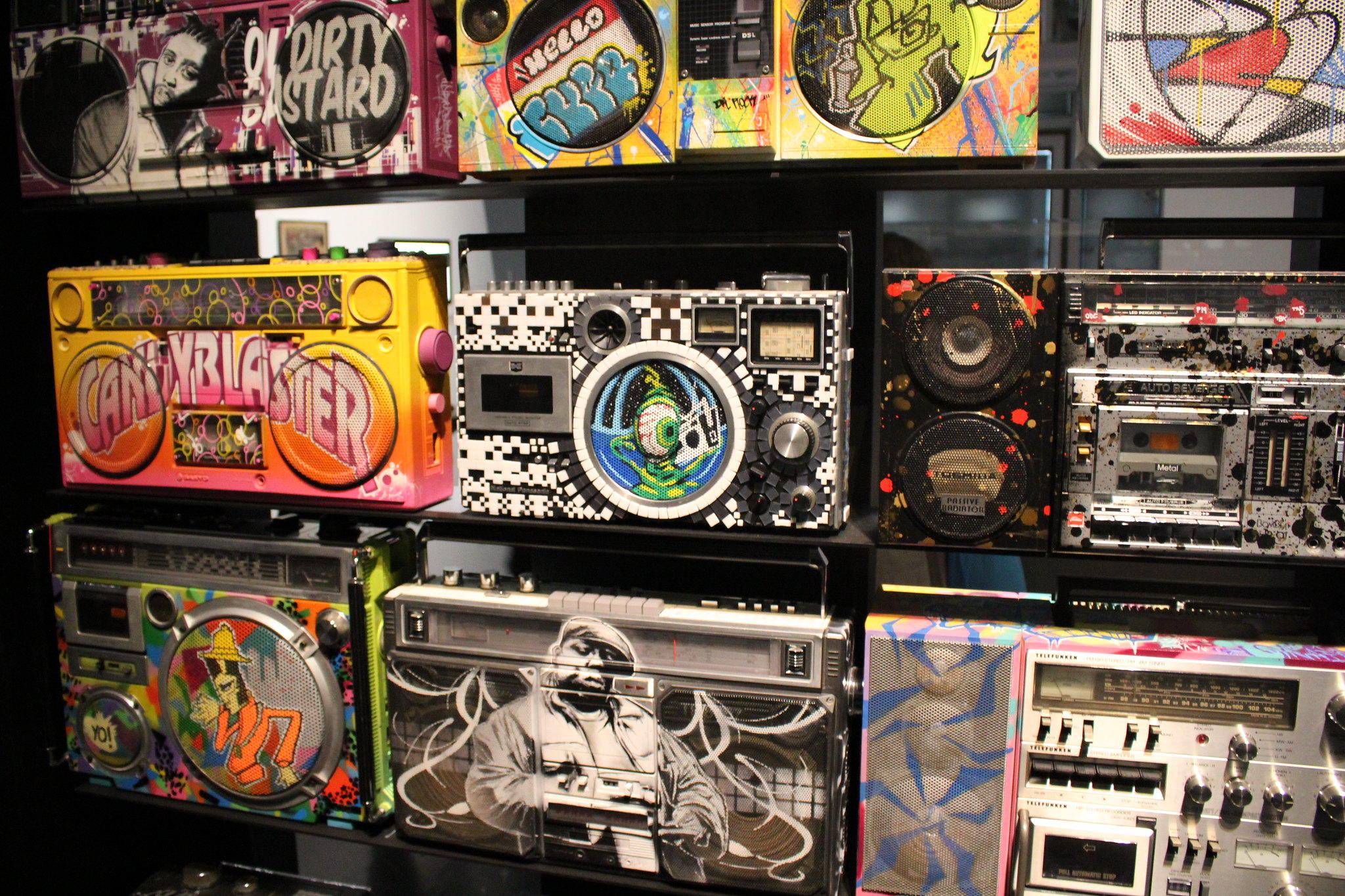 A museum exhibit showing decorated boomboxes
