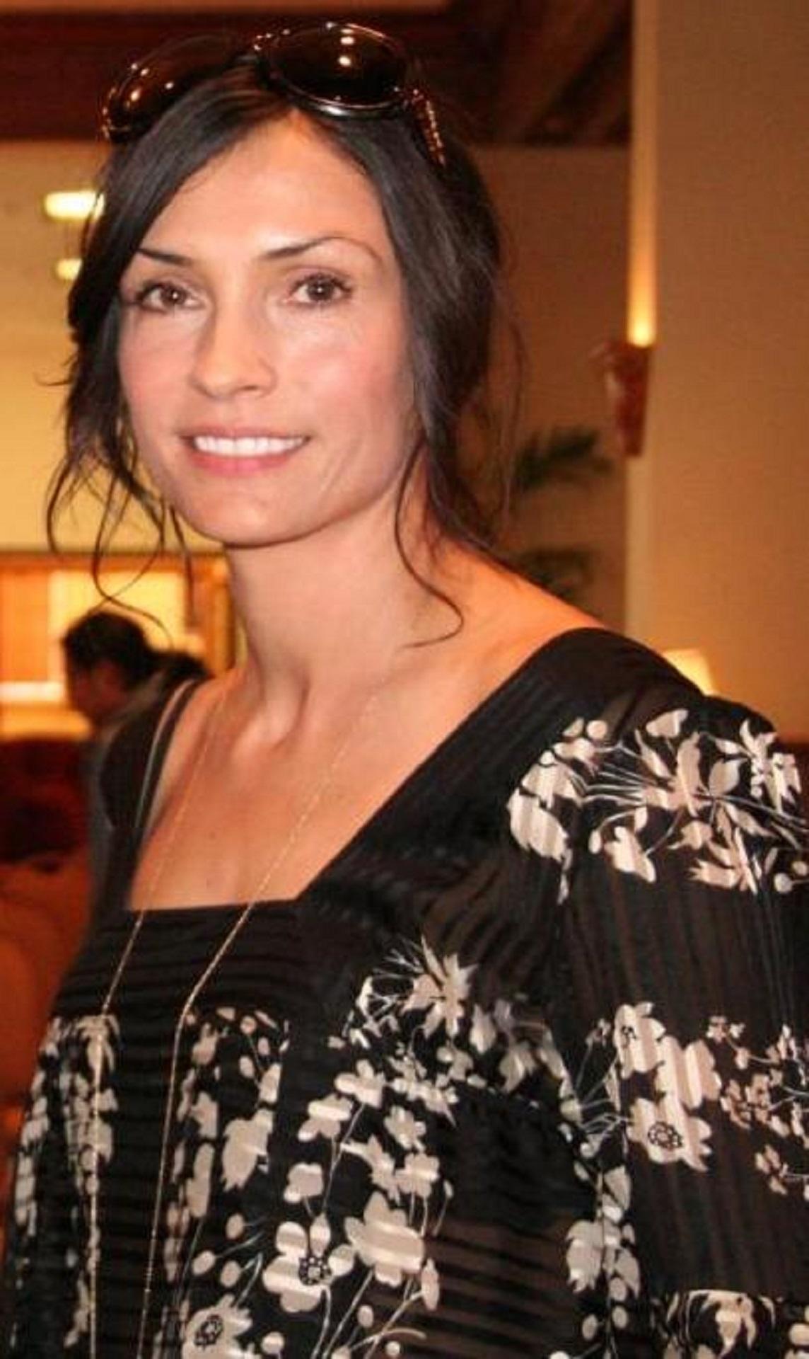 A woman wearing a black and gold dress. 